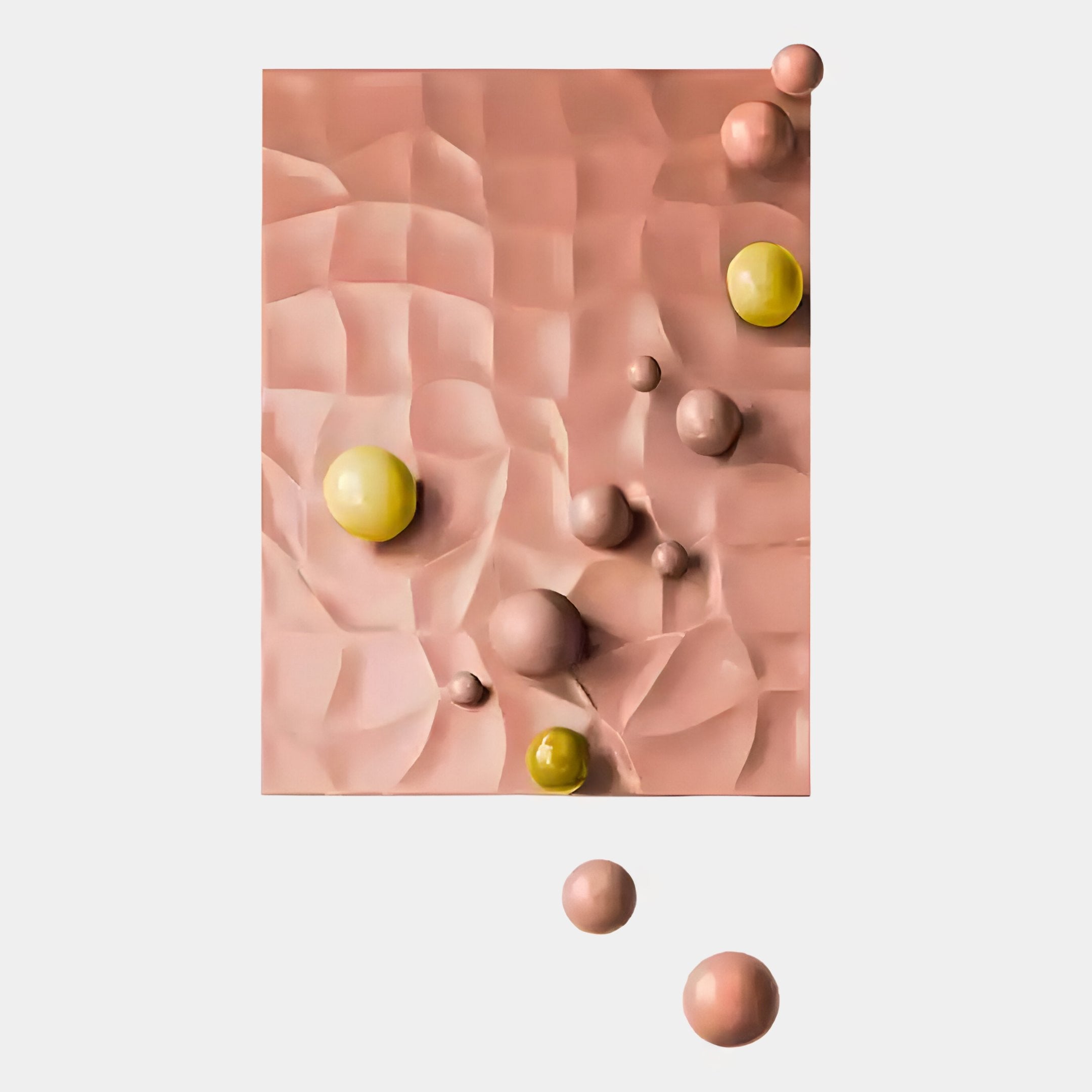 The Orbison Peach 3D Wood Relief Wall Art With Floating Metal Ball by Giant Sculptures features a textured pinkish-beige rectangle with wave patterns and smooth yellow and peach spheres, some floating against a white background.