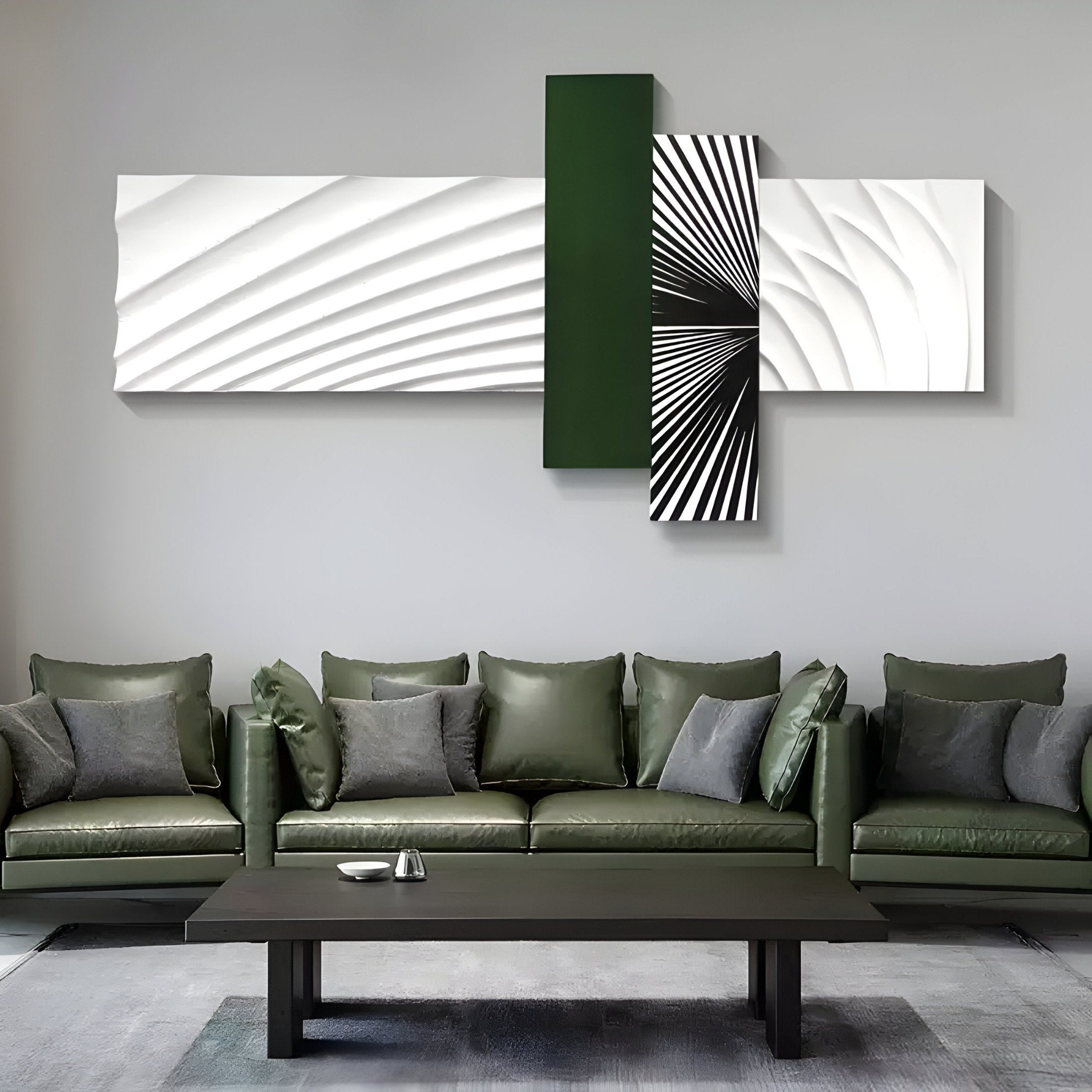 A contemporary living room features green leather sofas and gray cushions. The focal point is Giant Sculptures Axentra Deep Green & White Geometric Wood Relief 3D Wall Art, complemented by a sleek black coffee table that enhances the modern vibe.