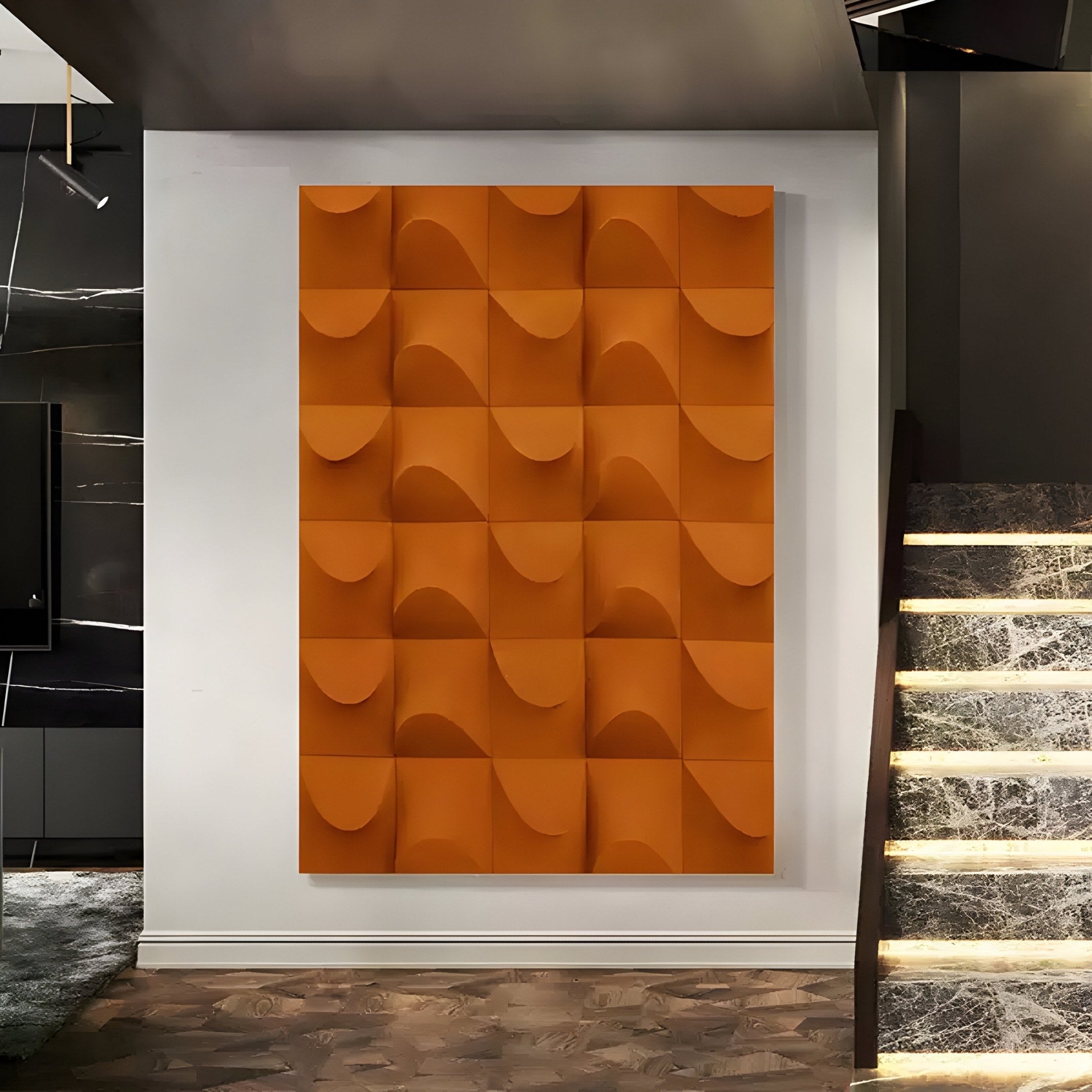 The Ondula Textured Orange Wood Relief 3D Wall Art by Giant Sculptures enhances a modern interior with a marble staircase to the right and dark-toned decor to the left, featuring a grid of square tiles with curved, alternating raised surfaces.