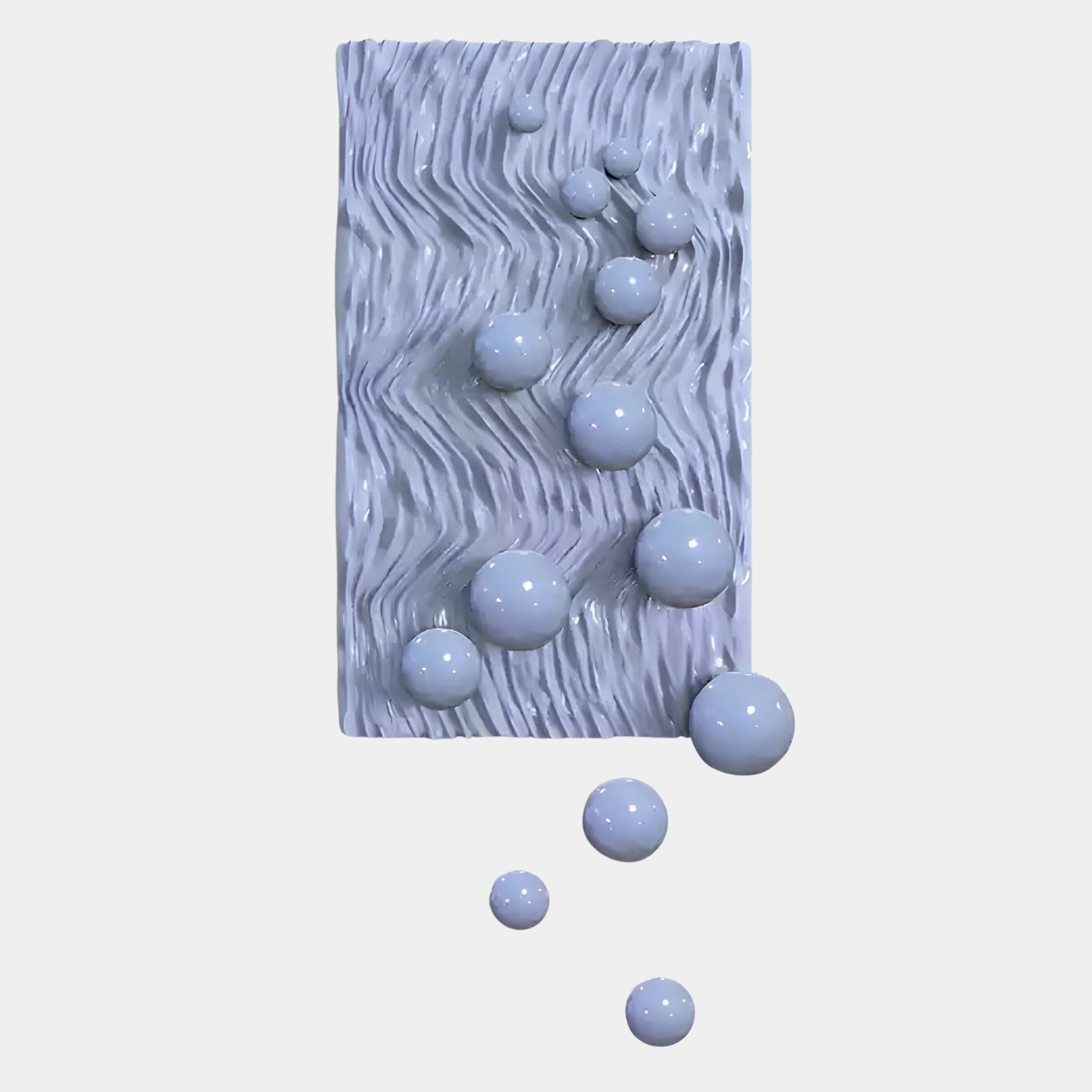 The Fluxion Lavender 3D Wood Relief Wall Art With Metal Ball by Giant Sculptures features a rectangular, textured white panel with wavy grooves and glossy spheres, making it perfect Minimalist Contemporary Decor for plain backgrounds.