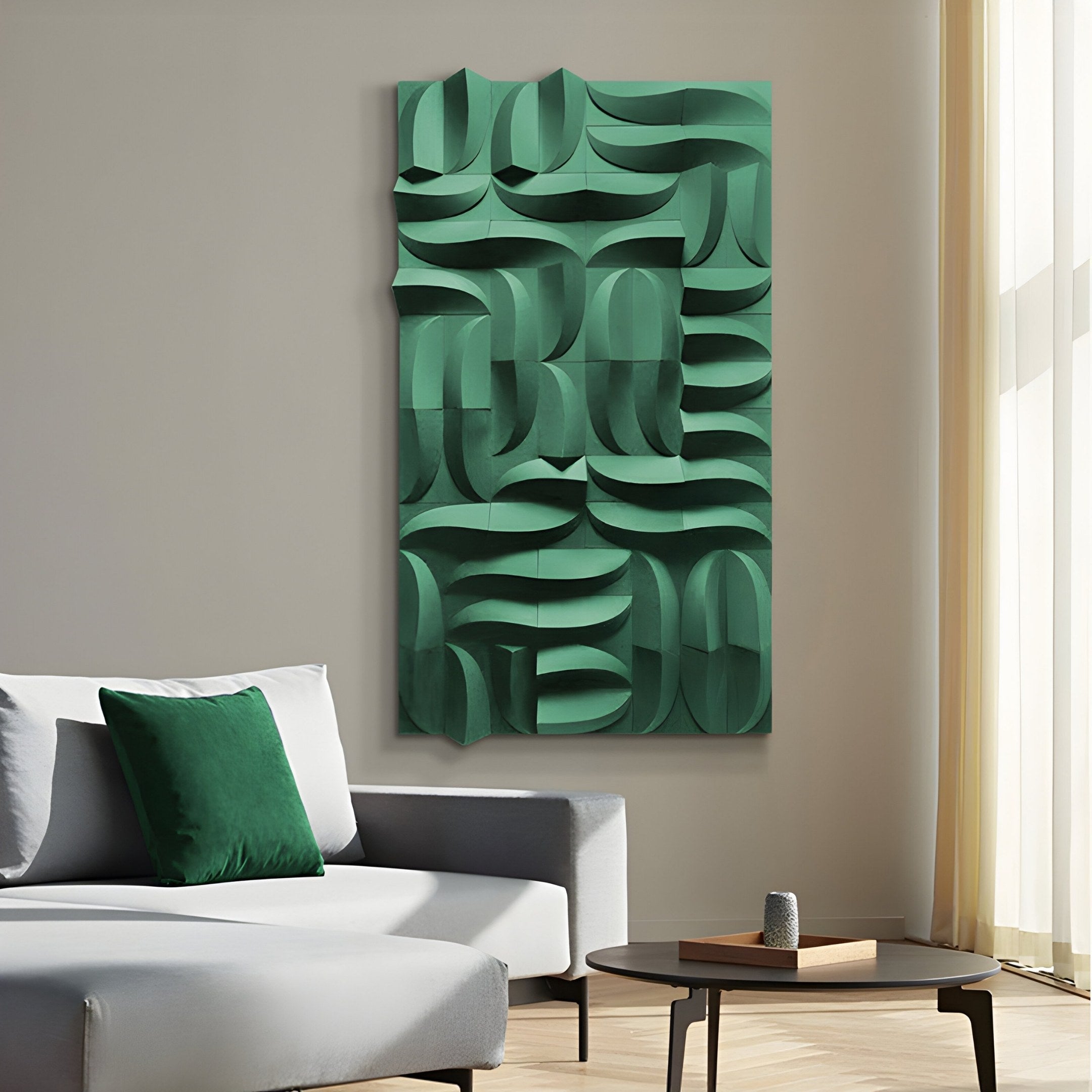 A modern living room showcases a gray sofa with green pillows, a round wooden coffee table with decor, and the striking Ombra Green Hand-Painted Sandstone 3D Wood Relief Wall Art by Giant Sculptures. Soft natural light through beige-curtained windows enhances the contemporary elegance.