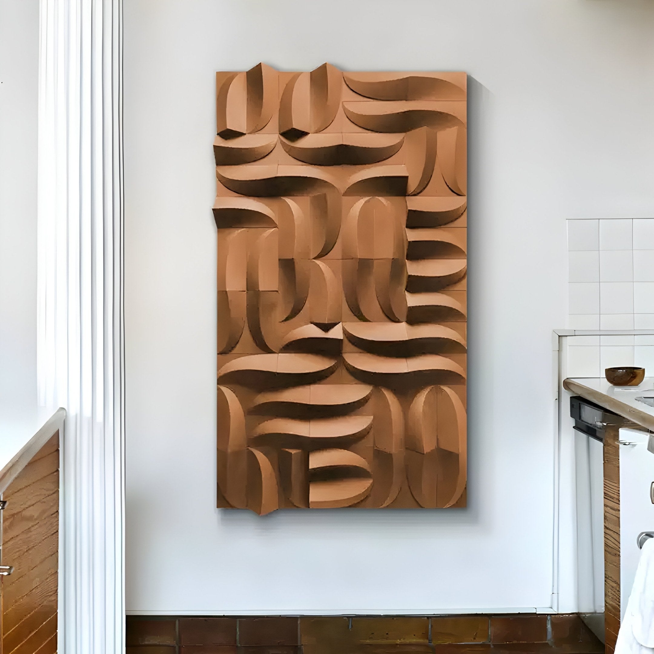 The modern kitchen features a striking piece of geometric wall art, the Ombra Brown Hand-Painted Sandstone 3D Wood Relief from Giant Sculptures. It showcases interlocking, curved shapes in varied shades of brown, creating a textured, three-dimensional effect on the white wall.