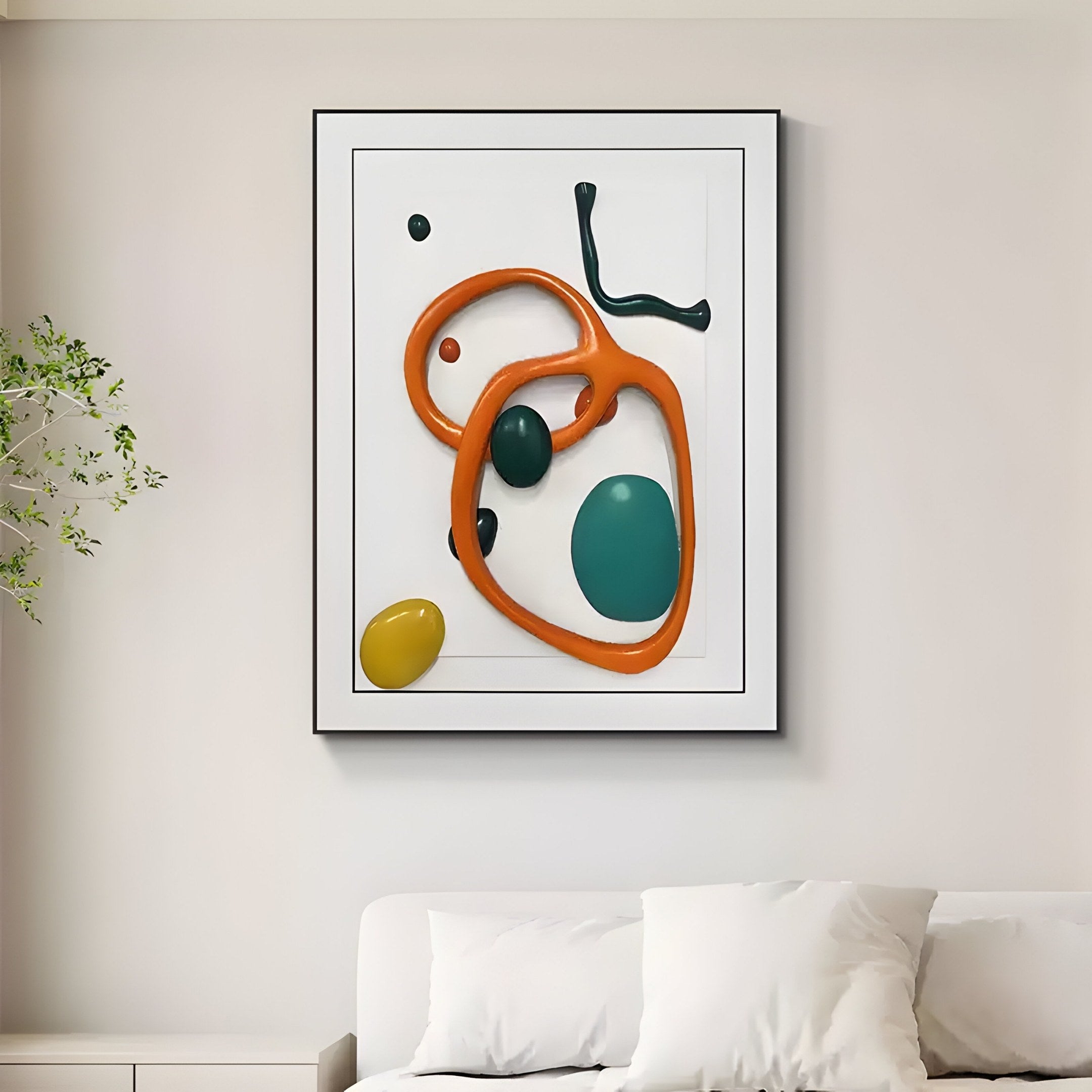 The Vitrus Orange & Green Abstract Wood Embossed 3D Wall Art by Giant Sculptures adorns a white wall above a white couch, featuring bold organic shapes in orange, teal, black, and yellow. A green plant is slightly visible on the left side of the image.