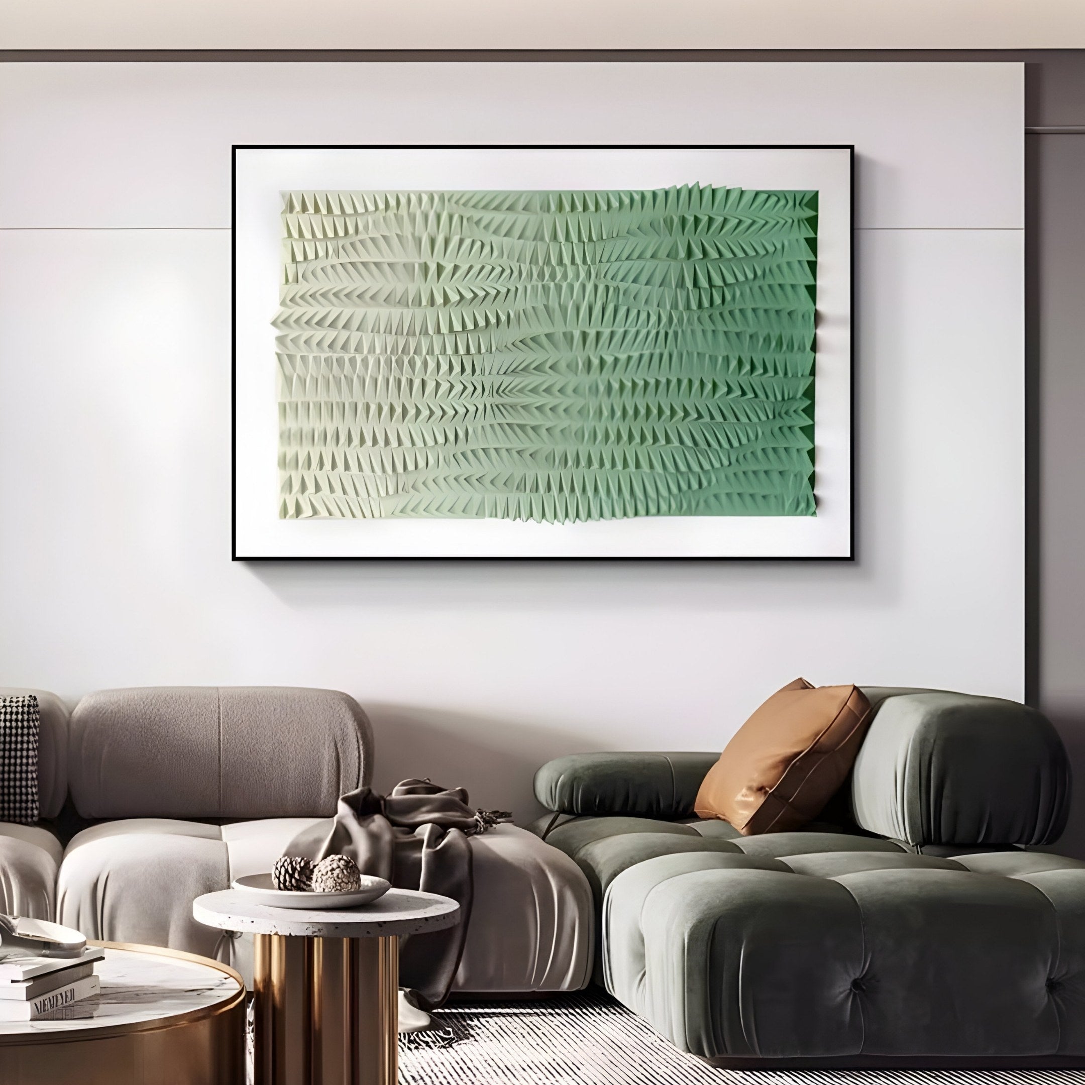 A modern living room includes the Elytrum Green Gradient Hand-Painted Wood Relief 3D Wall Art by Giant Sculptures, a gray sofa with brown and green cushions, a round marble coffee table with decor, and a plush green chair on a striped rug.