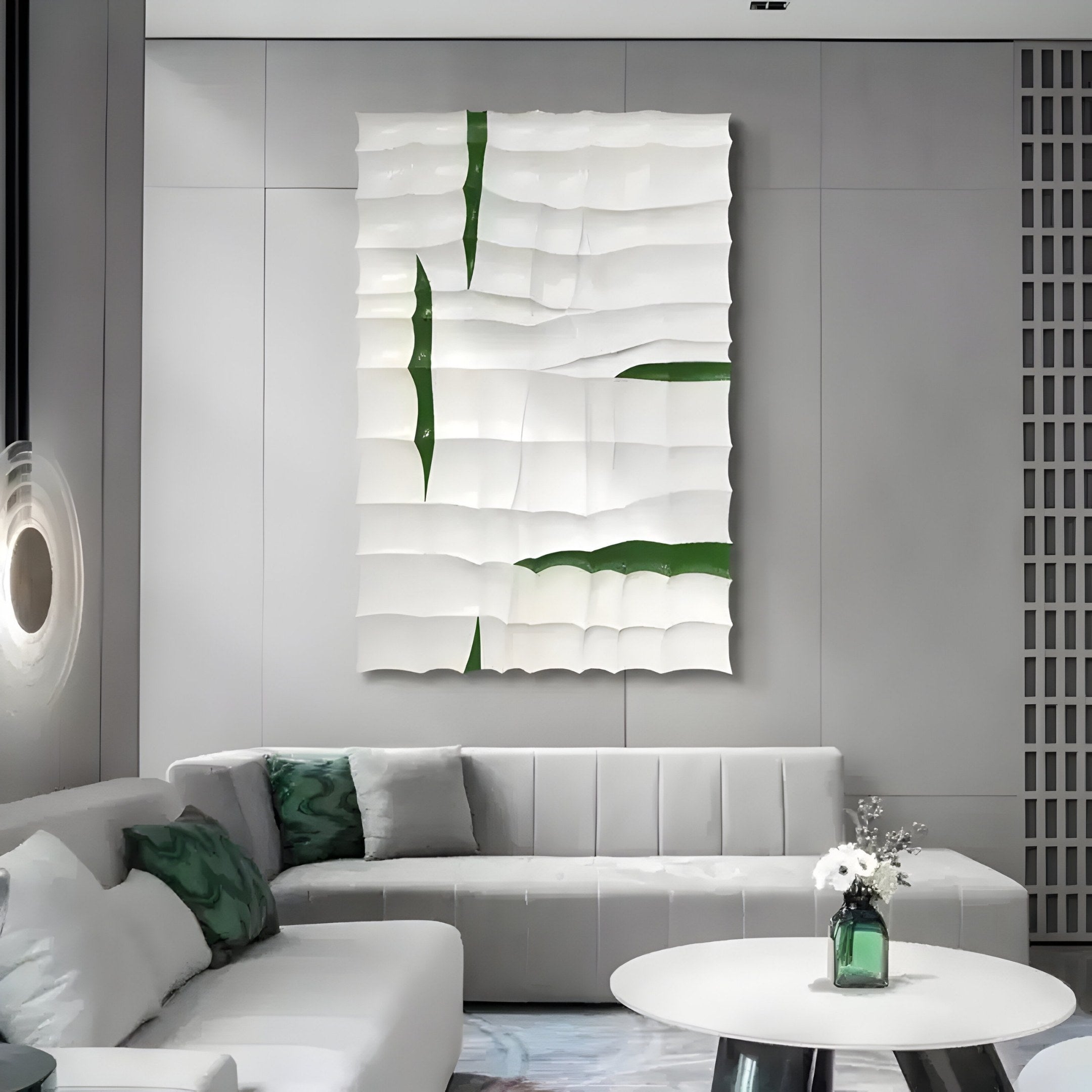 A contemporary living room includes a white L-shaped couch, green cushions, and a round coffee table with flowers. The Striata White & Green Wood Carving by Giant Sculptures adorns the wall above the couch as an abstract 3D focal point.