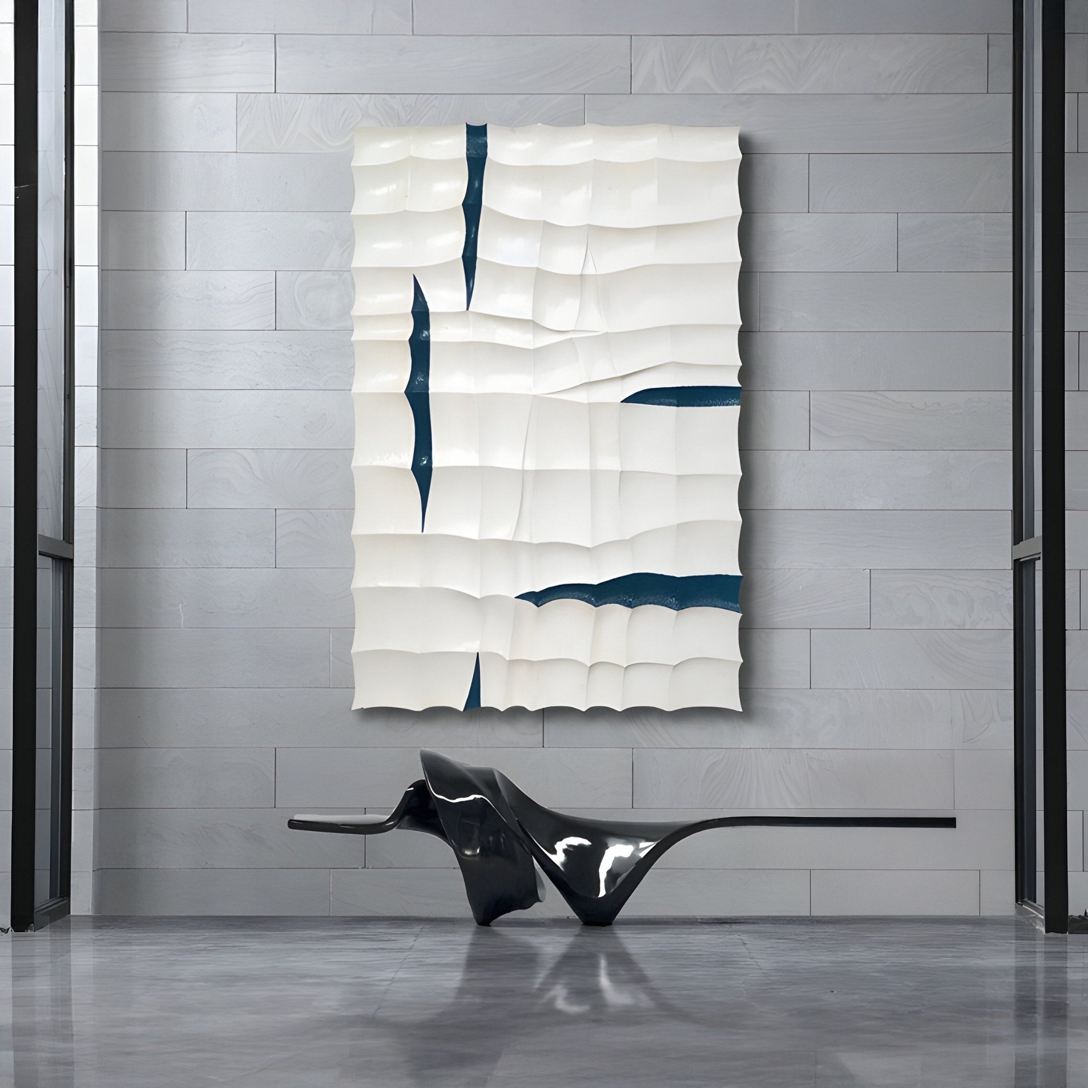 Striata White & Blue Wood Carving 3D Wall Art by Giant Sculptures features wave-like, wavy white panels and dark blue lines on a gray tiled wall. Below it, theres a sleek black bench with smooth curves.