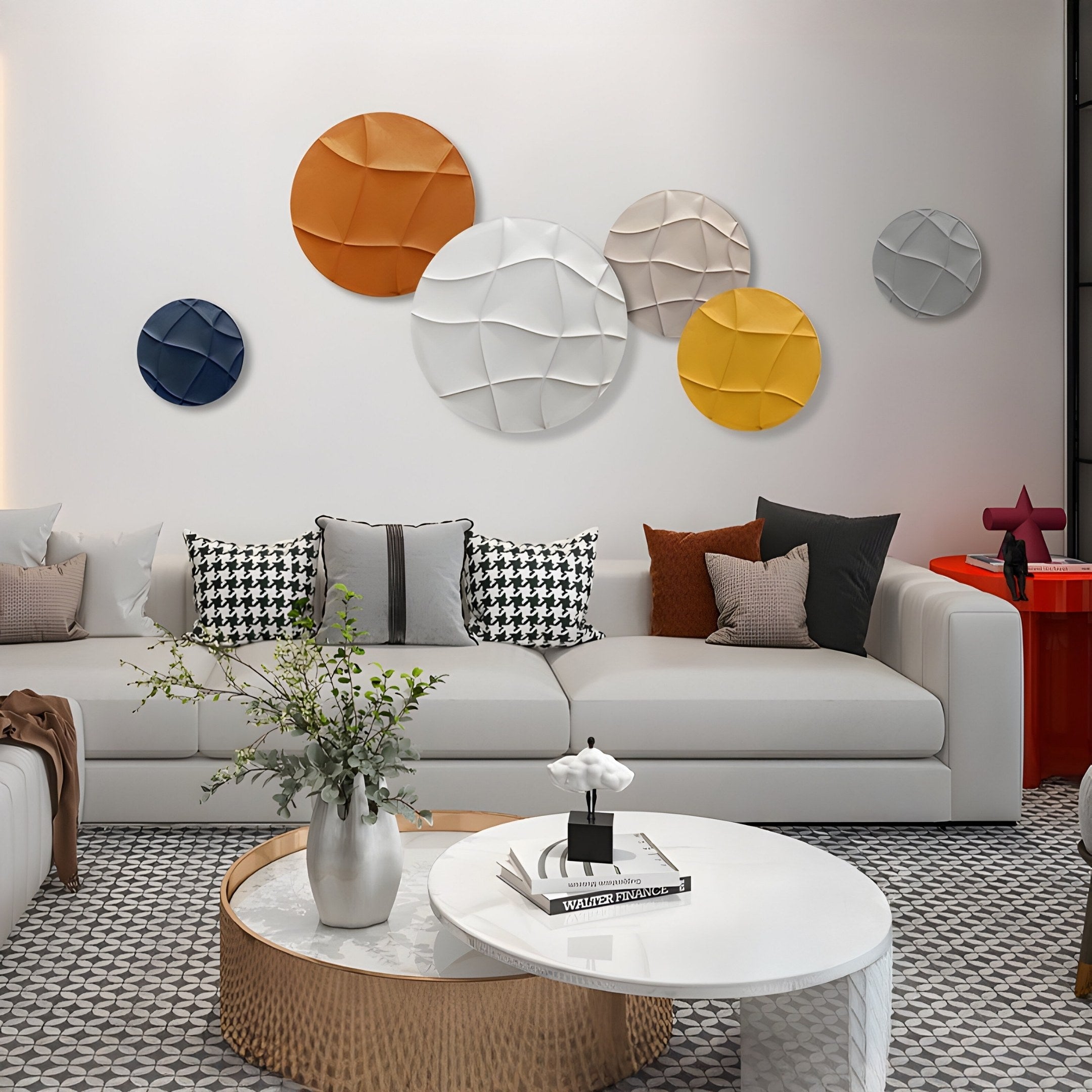 A modern living room features a white sofa with assorted pillows and an Orbura 6-Set Circular Earth-Tone 3D Wood Relief Wall Art by Giant Sculptures. Wooden panels accentuate the space, while a wooden coffee table with greenery and a book enhances the contemporary vibe.