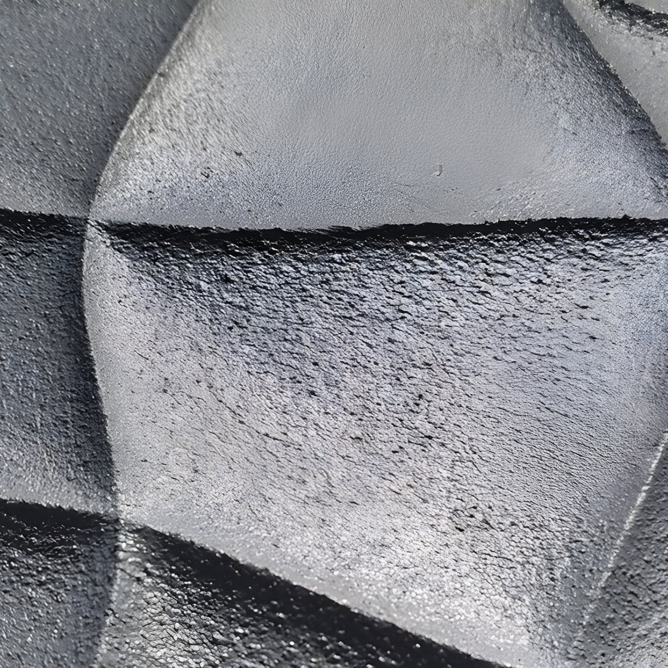 The Orbura 5-Set Circular Grey & Yellow 3D Wood Relief Wall Art by Giant Sculptures features a textured black surface with angular patterns, creating dynamic shadows and highlights. Its varying shades of gray and black add depth and dimension.
