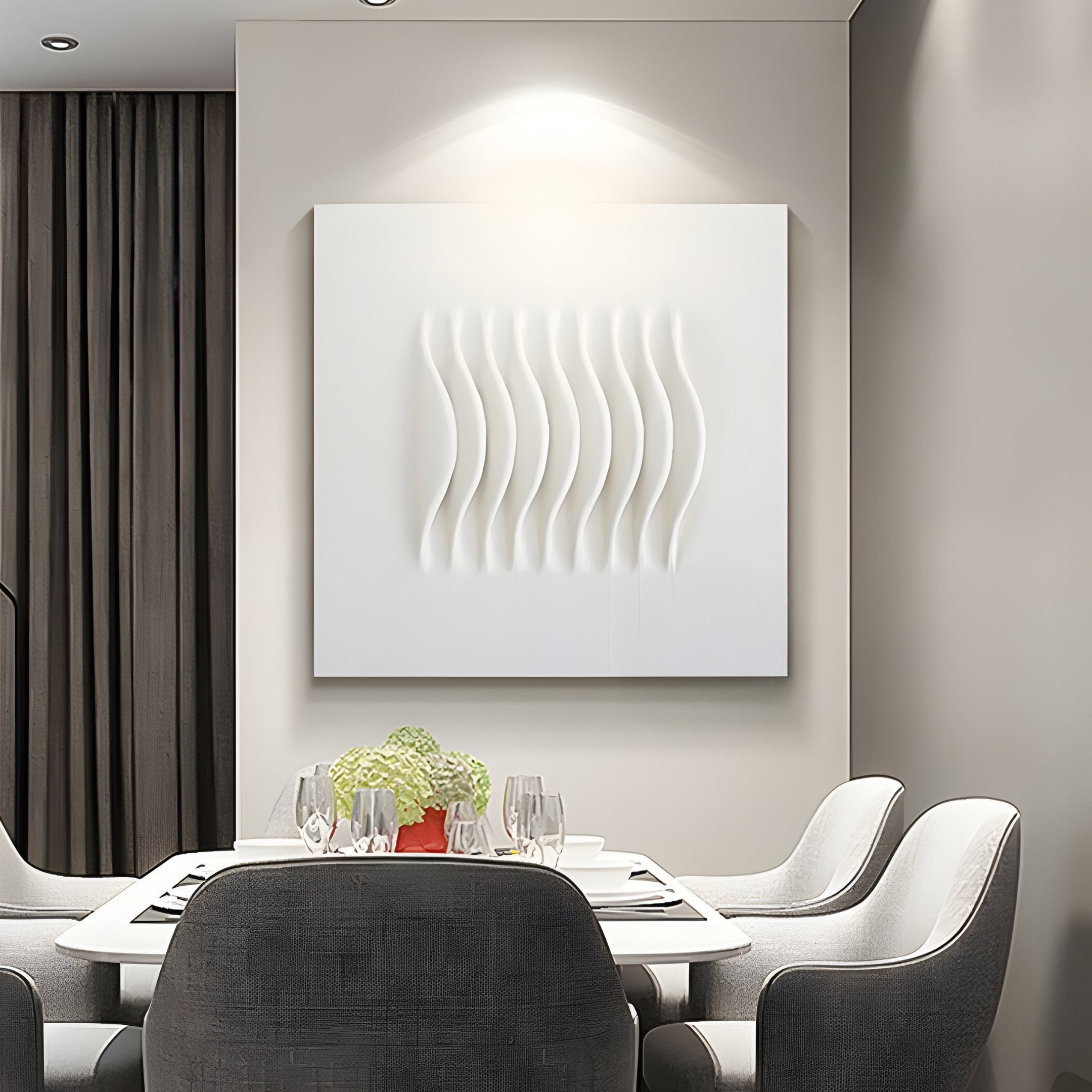 A modern dining room exudes serenity with a rectangular table set for four, complete with white plates, wine glasses, and napkins. Light gray upholstered chairs complement the Giant Sculptures Ondara Wave White Square Wood Relief 3D Wall Art hanging gracefully on the beige wall.