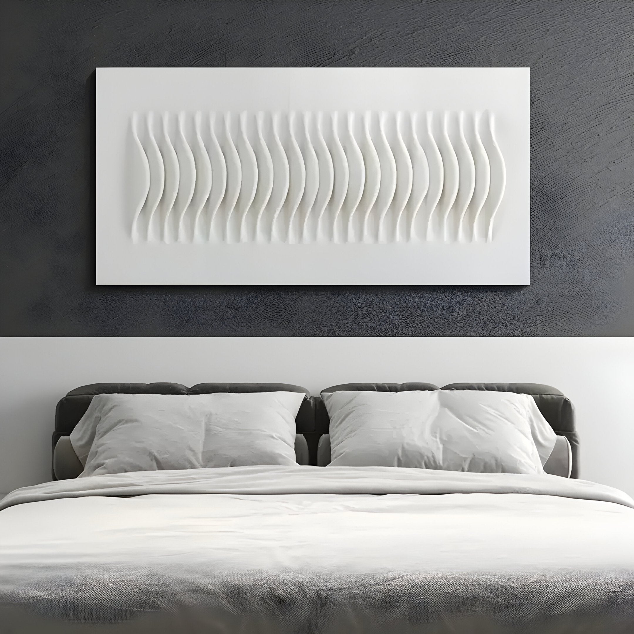 A modern bedroom showcases a gray bed with white pillows and comforter, complemented by the Giant Sculptures Ondara Wave White Horizontal Wood Relief 3D Wall Art on a textured wall for a minimalist aesthetic.