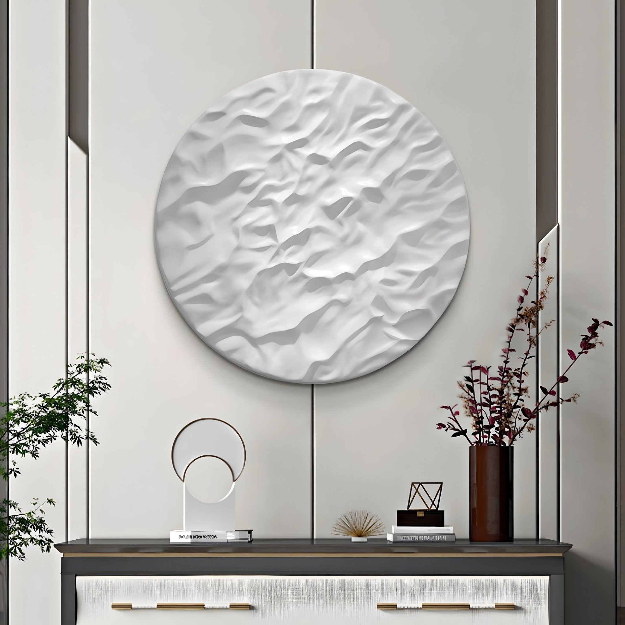 A modern interior features the Orenda Organic Wave White Wood Relief 3D Wall Art by Giant Sculptures above a console table. The table displays a decorative arch, small sculptures, and a plant vase. This minimalist décor in neutral tones enhances the rooms elegance.