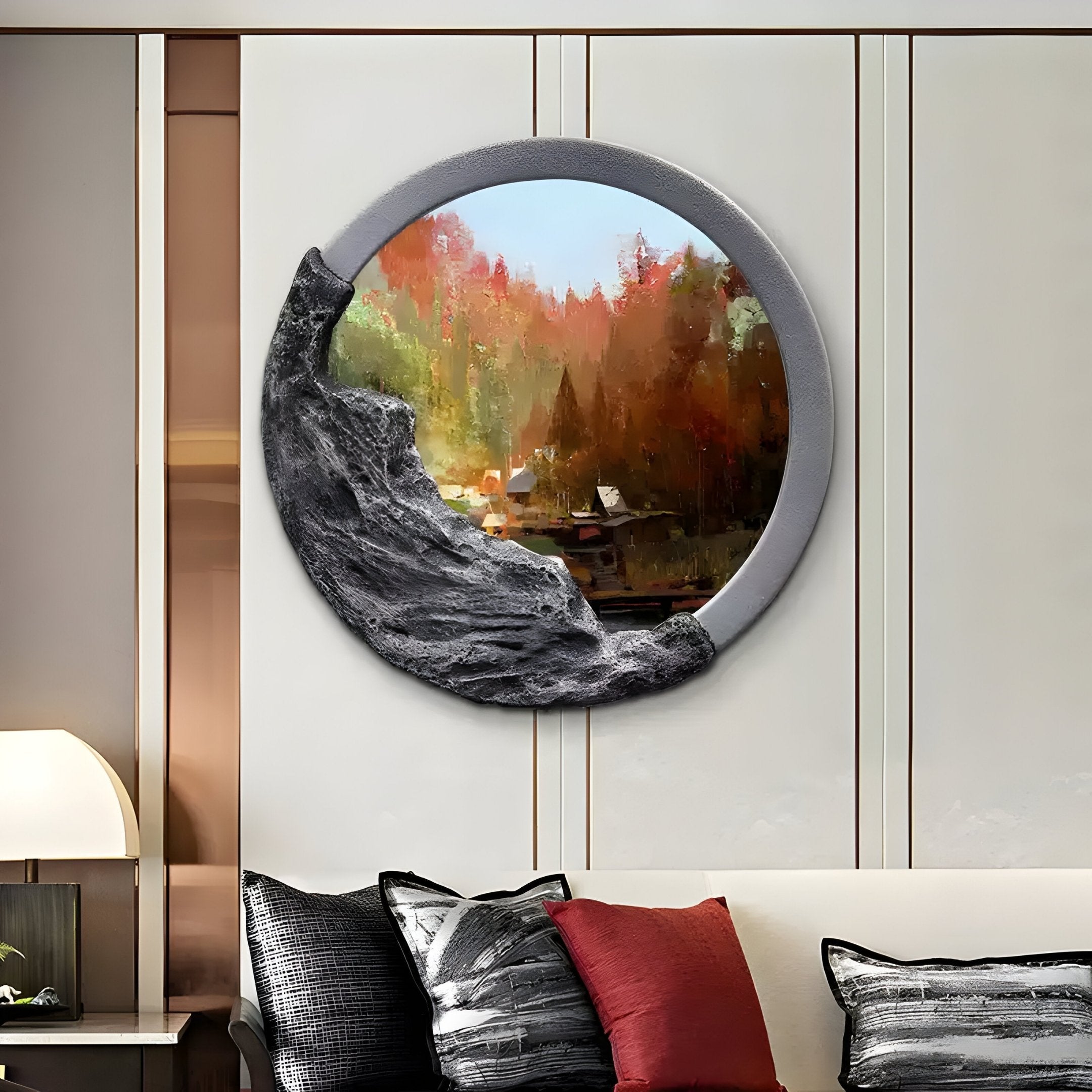 Giant Sculptures Sylvara Autumn Woods Hand-Painted Wood Relief 3D Wall Art decorates a modern wall with an autumn forest theme, featuring a textured, rocky frame. Below it, a sofa with red, black, and gray cushions sits beside an illuminated table lamp.