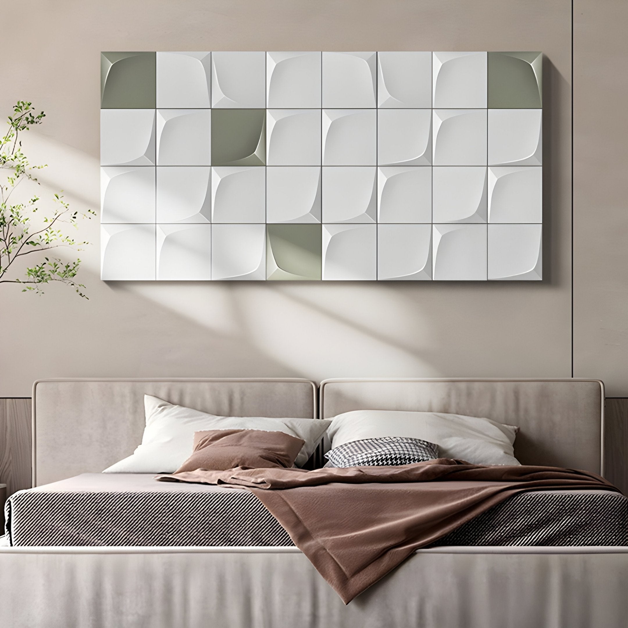 A minimalist bedroom includes a beige bed adorned with cushions and a brown throw. Above, Giant Sculptures Averra White & Sage Grid Block Wood Relief 3D Wall Art adds modern leaf patterns. A small plant is on the left, and soft lighting casts gentle shadows, enhancing the tranquil space.