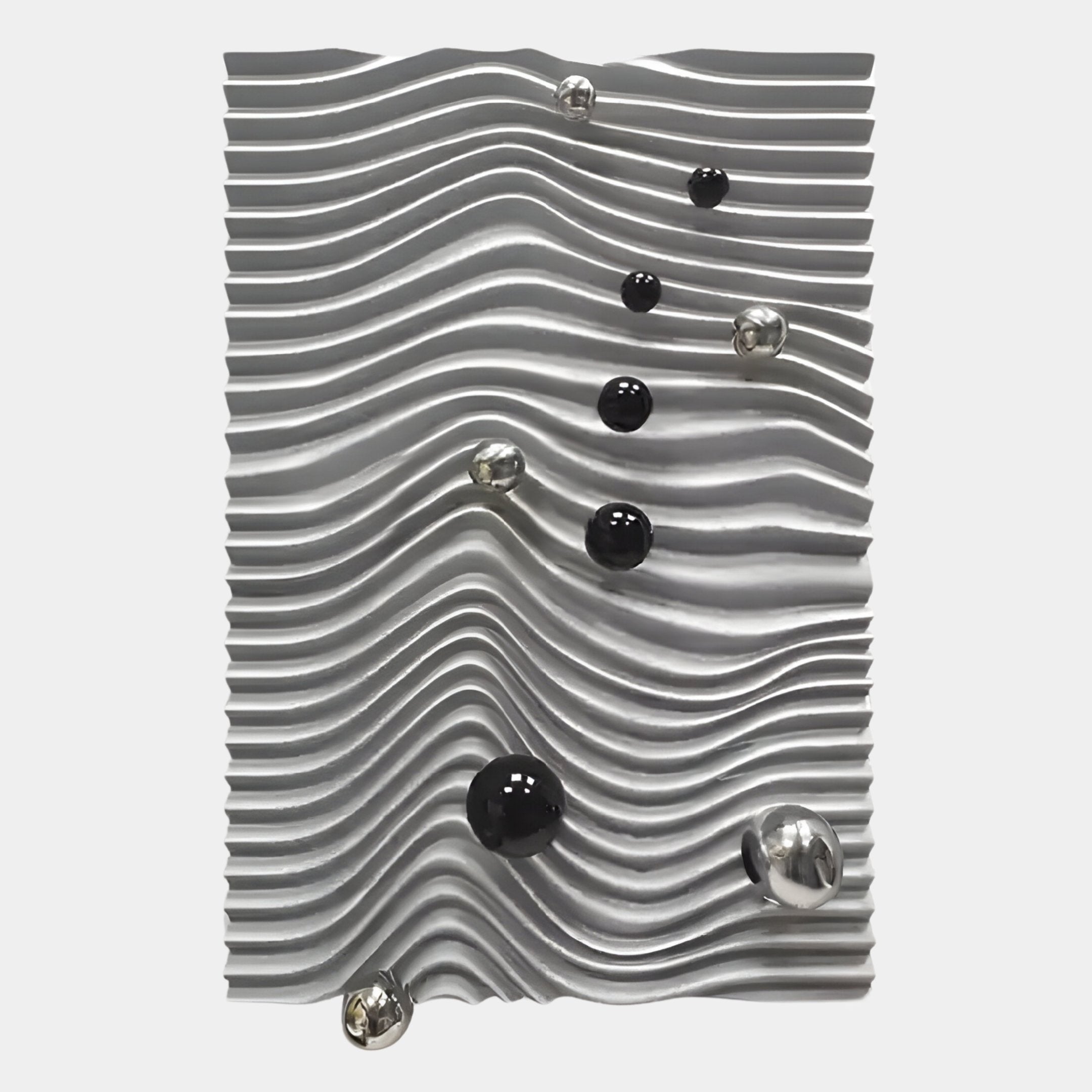 Metallic and black spheres rest on wavy silver ridges in the Calidora Wave Sculpted Textured 3D Relief Wall Art by Giant Sculptures, their random placement across the textured surface creating a striking modern look.