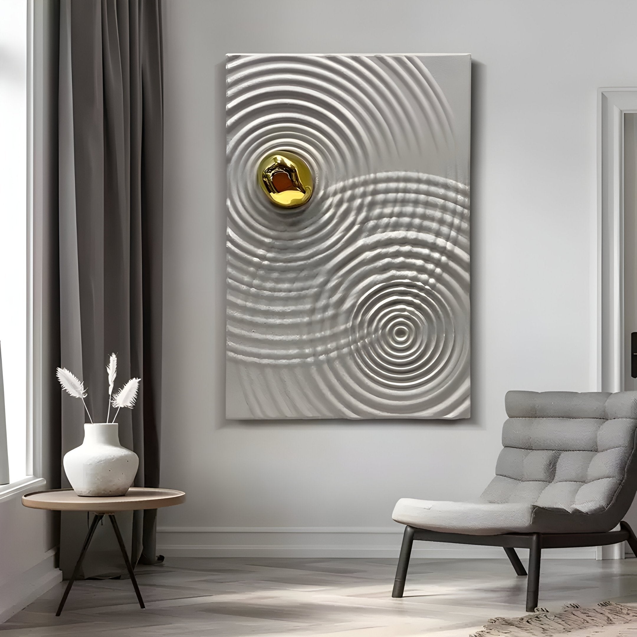 A modern living room features a gray armchair, round table, and the stunning Calidora Golden Ripple Textured 3D Relief Wall Art by Giant Sculptures. A white vase with dried flowers sits atop the table, while gray curtains and soft lighting complete the scene.