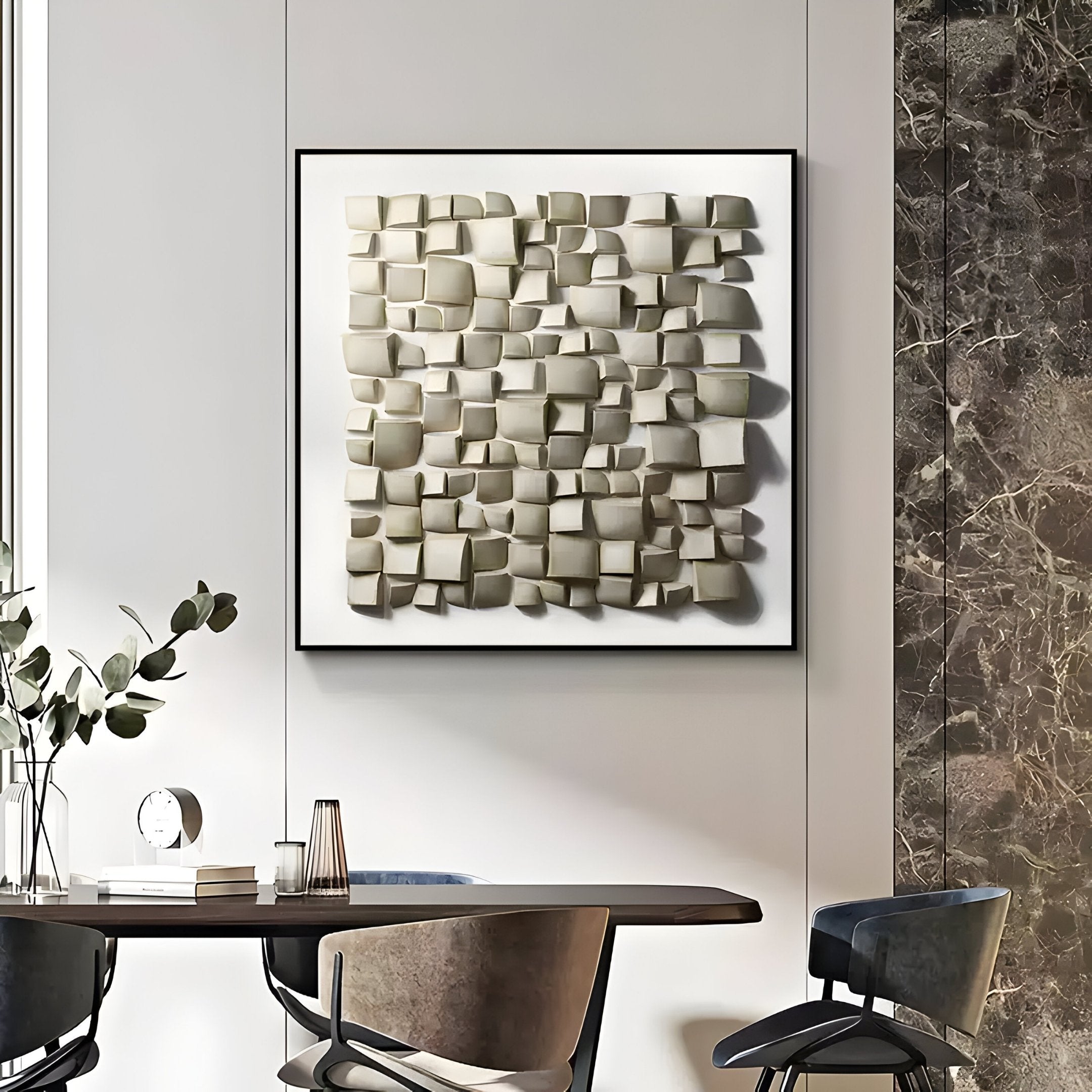 A modern dining area includes a round table with chairs. The wall is adorned with the Exalta Wood Relief Framed 3D Wall Art by Giant Sculptures, featuring raised beige tiles. The space blends contemporary style and traditional craftsmanship with minimalist design, neutral colors, and decorative plants.