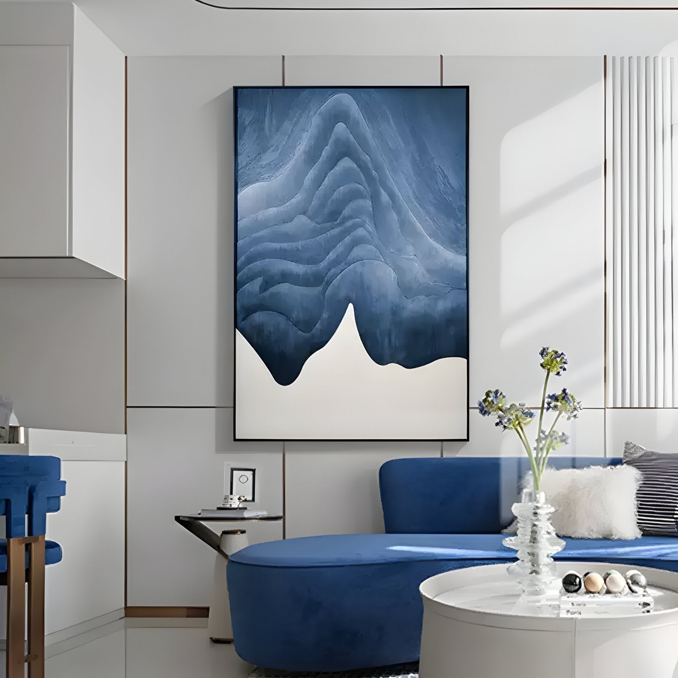 A modern living room with a blue curved sofa, round white coffee table, a flower vase, and Giant Sculptures’ Celoria Azure Tide Wood Carving 3D Wall Art above. The space is bright and features clean, minimalist decor.