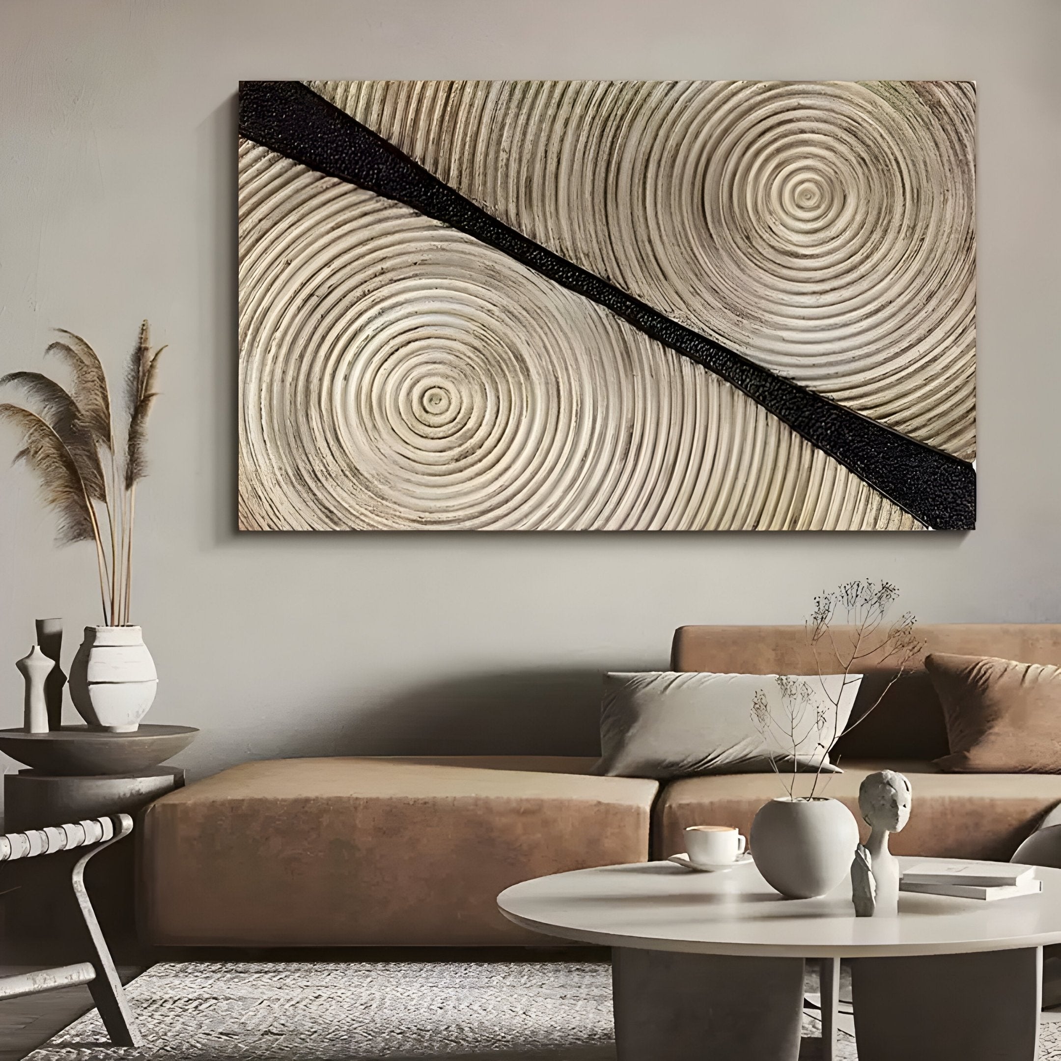 A neutral living room features a beige sofa, round white coffee table, minimalist decor, and the Artura Ivory Hand-Painted 3D Relief Wall Art by Giant Sculptures for a serene, modern touch.