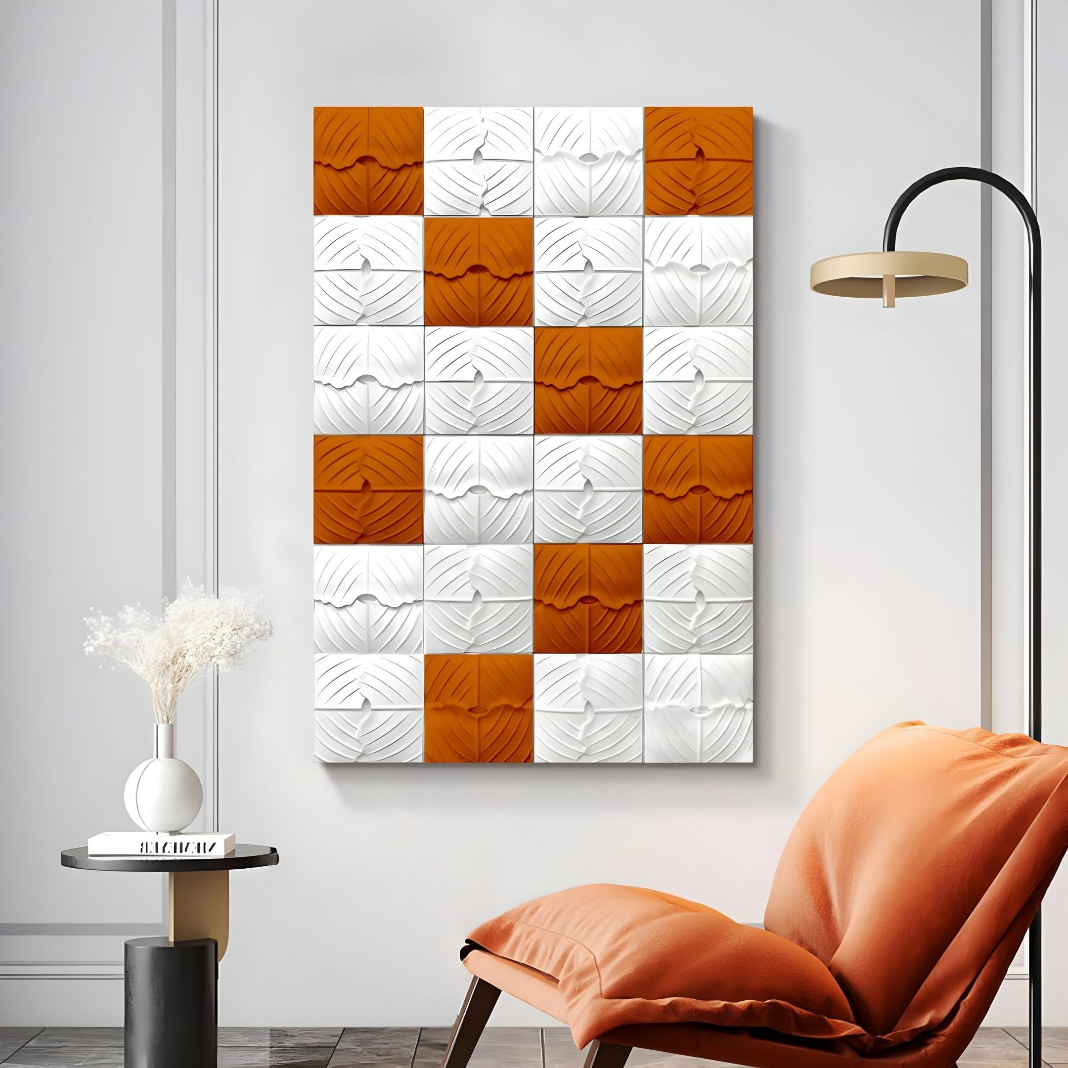 A modern living room showcases Giant Sculptures Vellura White & Orange Textured Wood Relief 3D Wall Art, alongside a round side table with white flowers, a curved orange chair, and a black floor lamp.