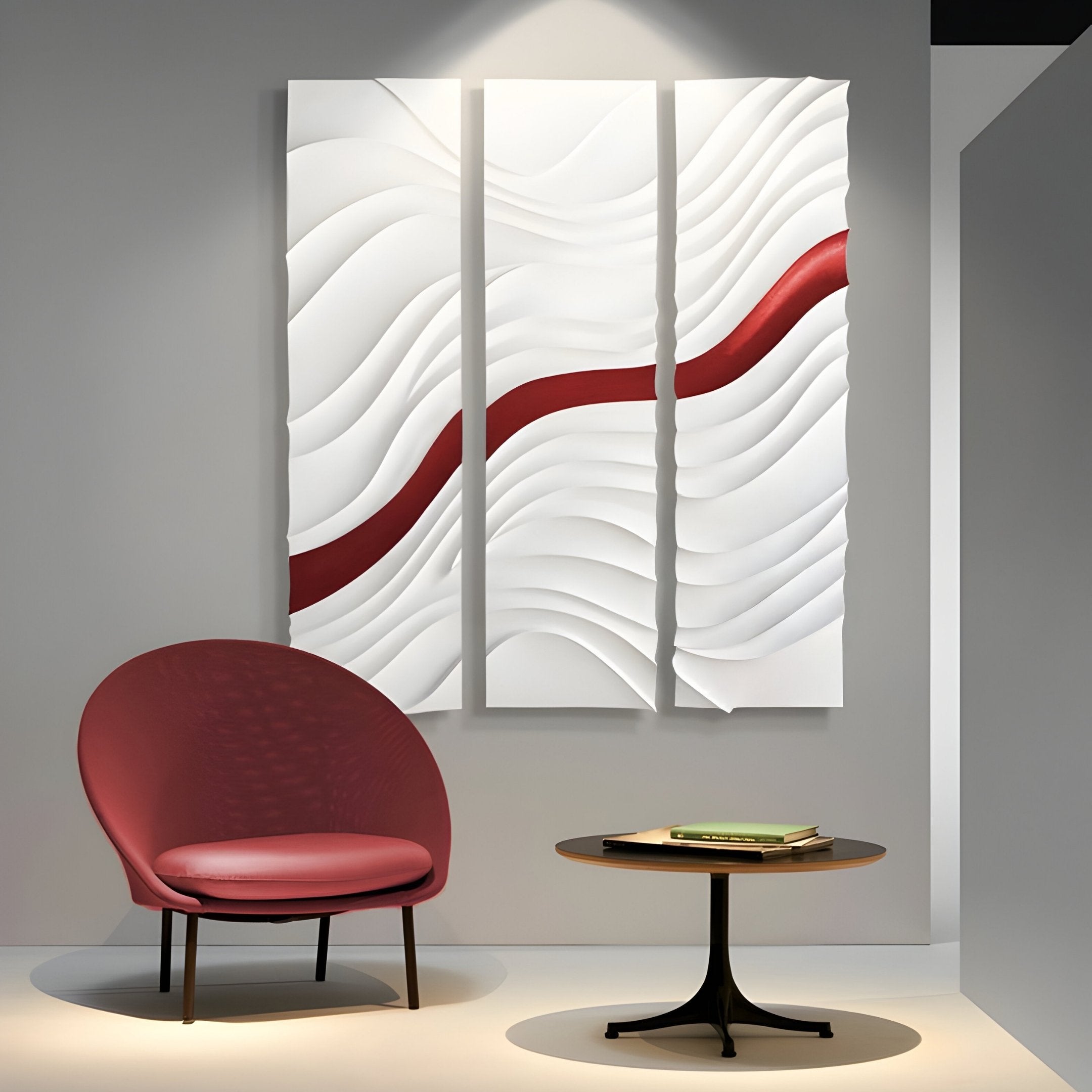 A modern room features a red chair, a round table with books, and the Evolva 3-Panel White & Red Wood Relief 3D Wall Art by Giant Sculptures—three panels with wavy white patterns and a bold red diagonal stripe.