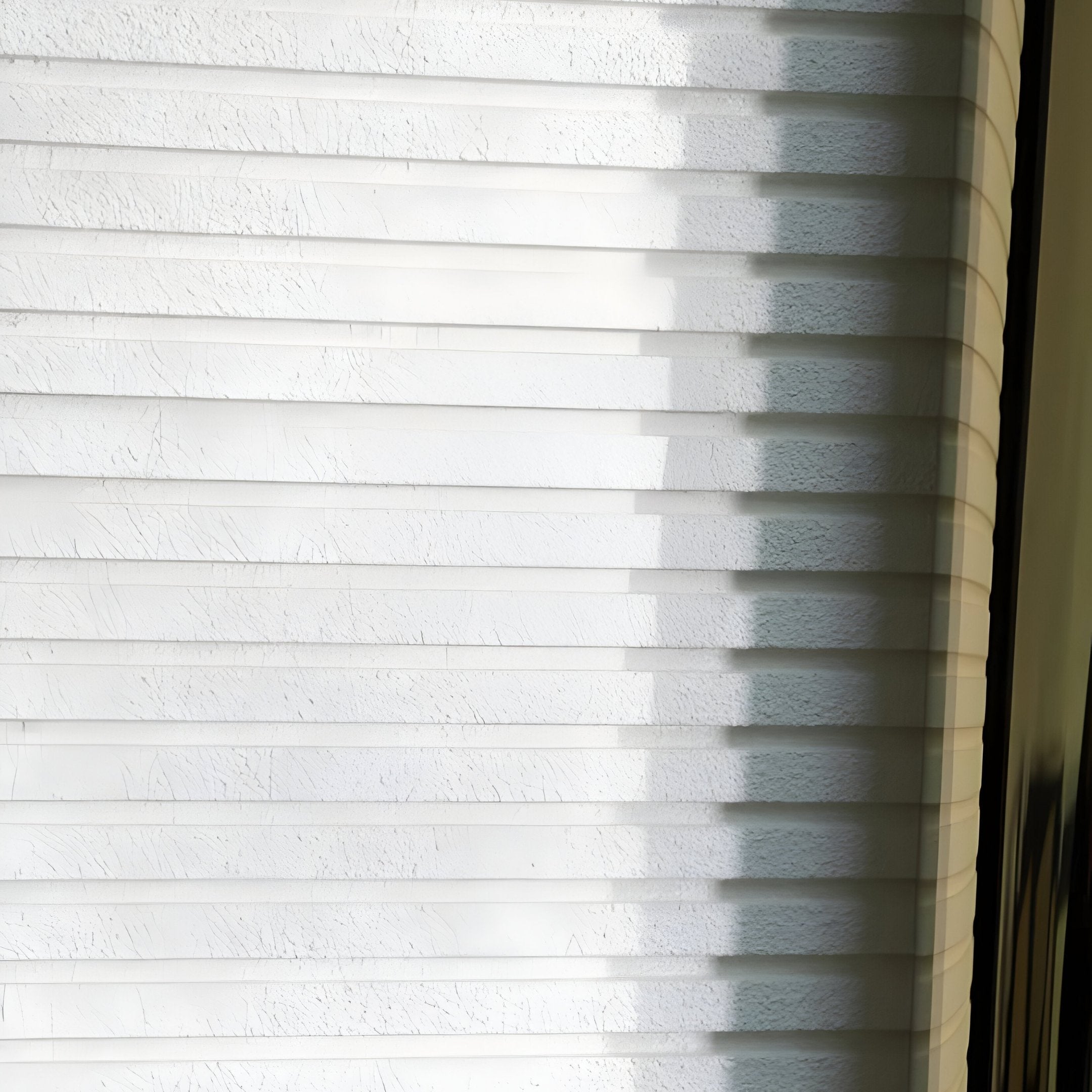 Close-up of Giant Sculptures Artevia Gold & White Geometric Wood Relief 3D Wall Art, with sunlight casting patterns of light and shadow across the textured surface, highlighting its sculptural design from the left side.