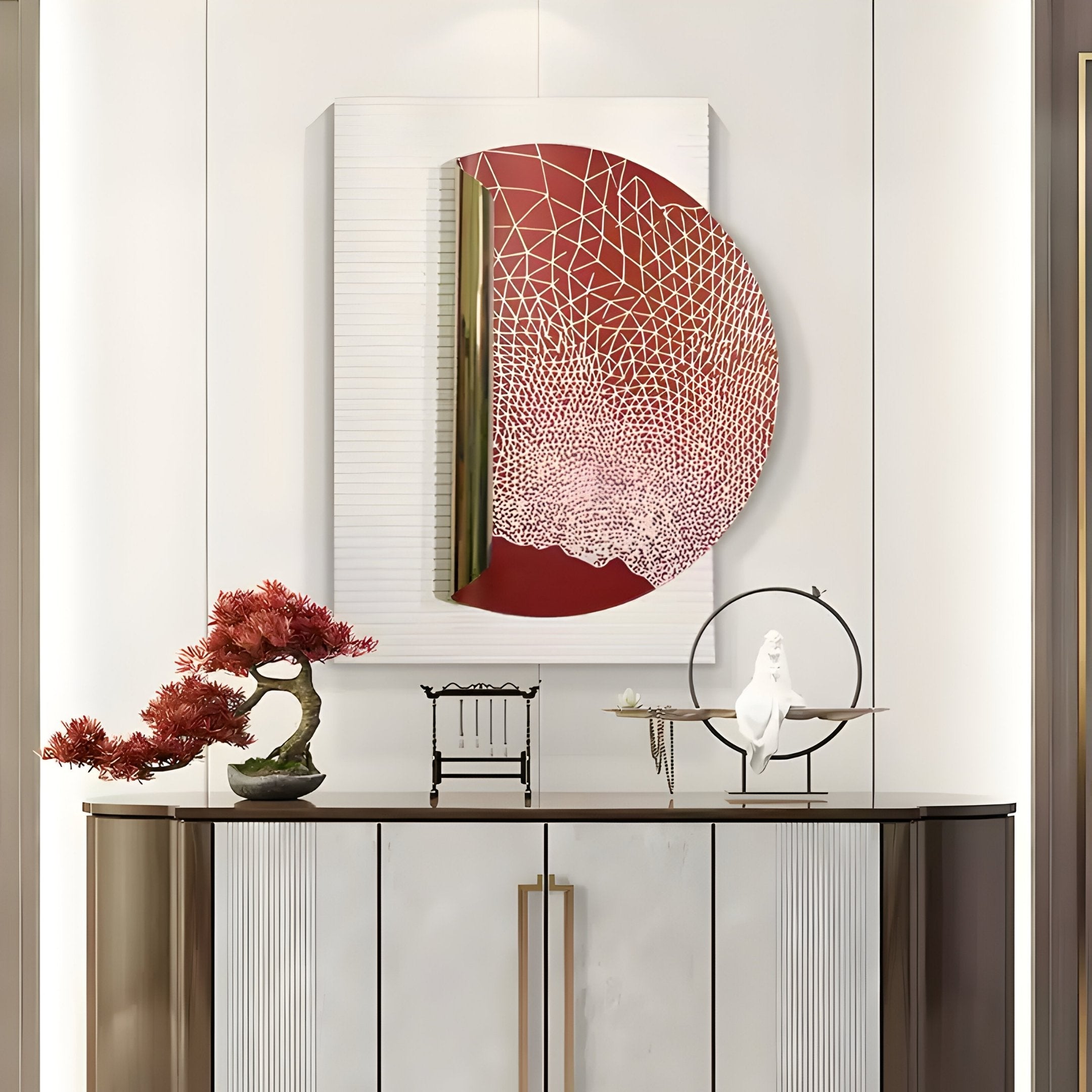 A minimalist sideboard with gold handles features a red bonsai, a small decorative chair, and Artevia Red & White Geometric Wood Relief 3D Wall Art by Giant Sculptures above. A white bird sculpture rests gracefully on a metal ring stand.
