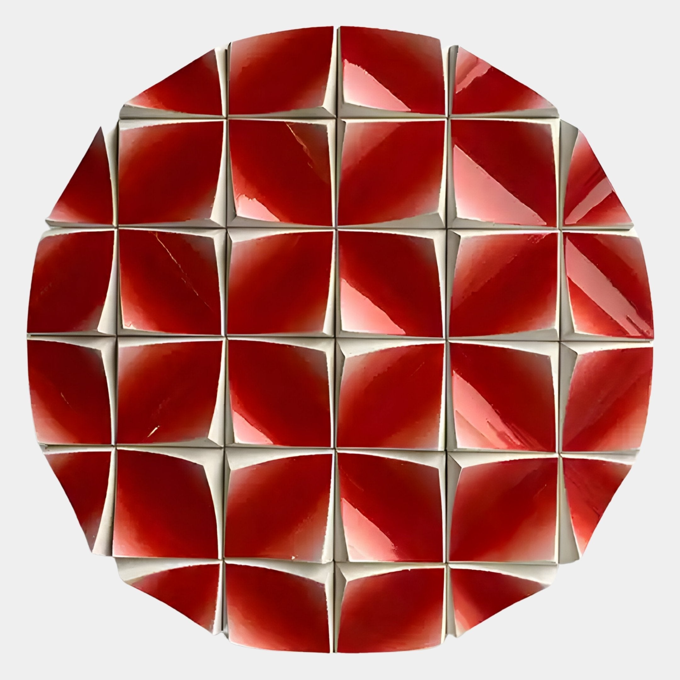 A circular arrangement of red, glossy, pyramid-shaped tiles with white edges forms the Incalia Red Circular Geometric Wood Relief 3D Wall Art by Giant Sculptures, creating a striking geometric pattern on a light background.