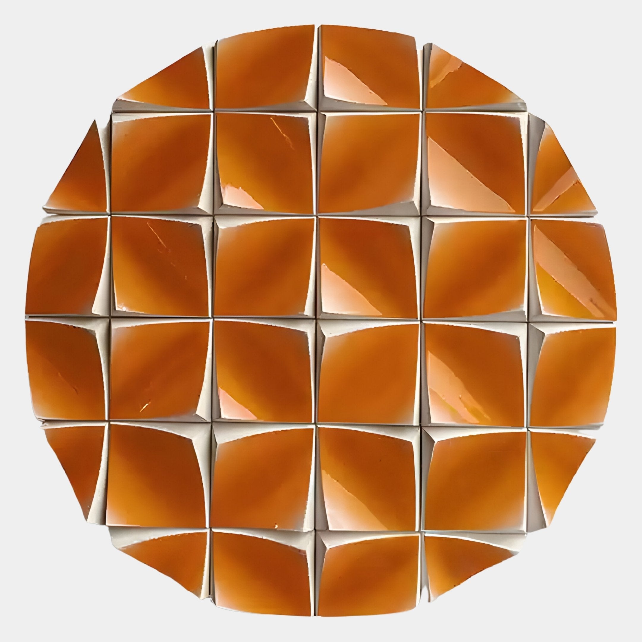 The Incalia Orange Circular Geometric Wood Relief 3D Wall Art by Giant Sculptures features glossy, pyramid-shaped tiles in a geometric pattern, each separated by white borders for a striking prismatic effect.