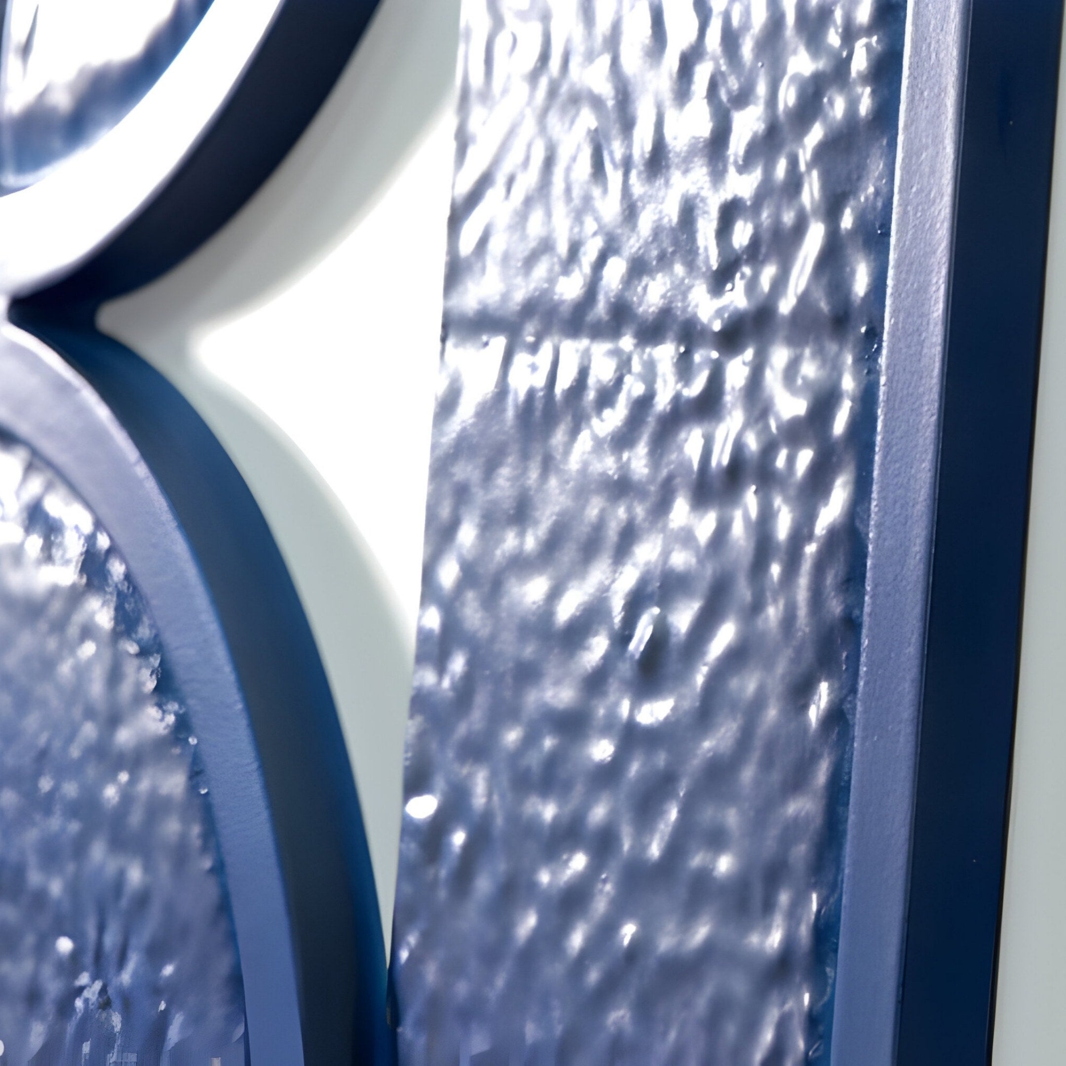 Close-up of Giant Sculptures Infinique Vertical Blue Abstract Wood Carving 3D Wall Art, featuring a blue textured surface with wavy patterns that interplay with light and shadow against a white background.