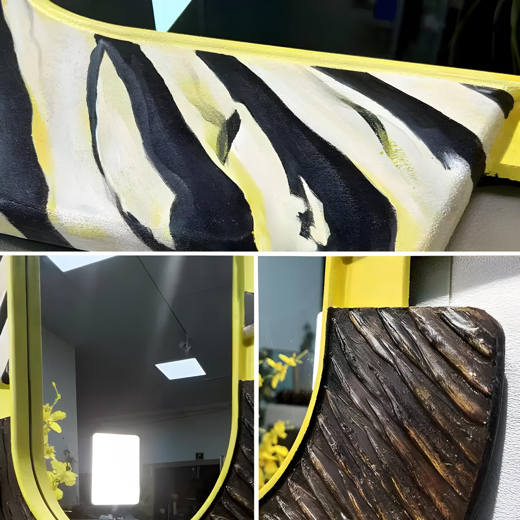 Close-up of Giant Sculptures Arcus Black & Yellow Zebra Stripes Mirror 3D Wooden Wall Art, featuring modern home decor elements with zebra stripes at the top and a dark brown textured frame with diagonal ridges at the bottom, along with vibrant yellow florals reflected in the mirror.
