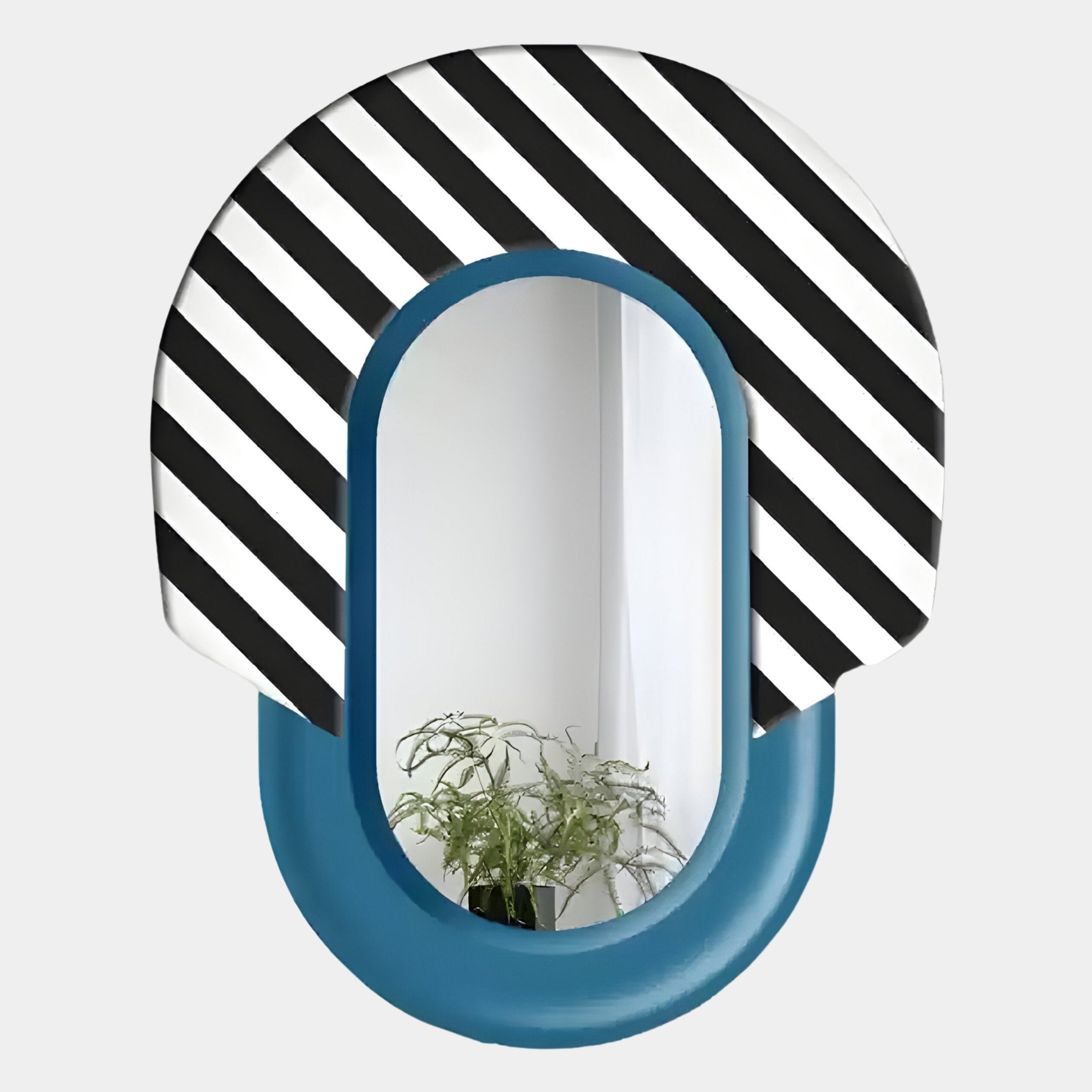 The Arcus Blue & Black-White Striped Mirror 3D Wooden Wall Art by Giant Sculptures features an oval design with a bold striped top and solid blue base; a green leafy plant is reflected in this striking piece.