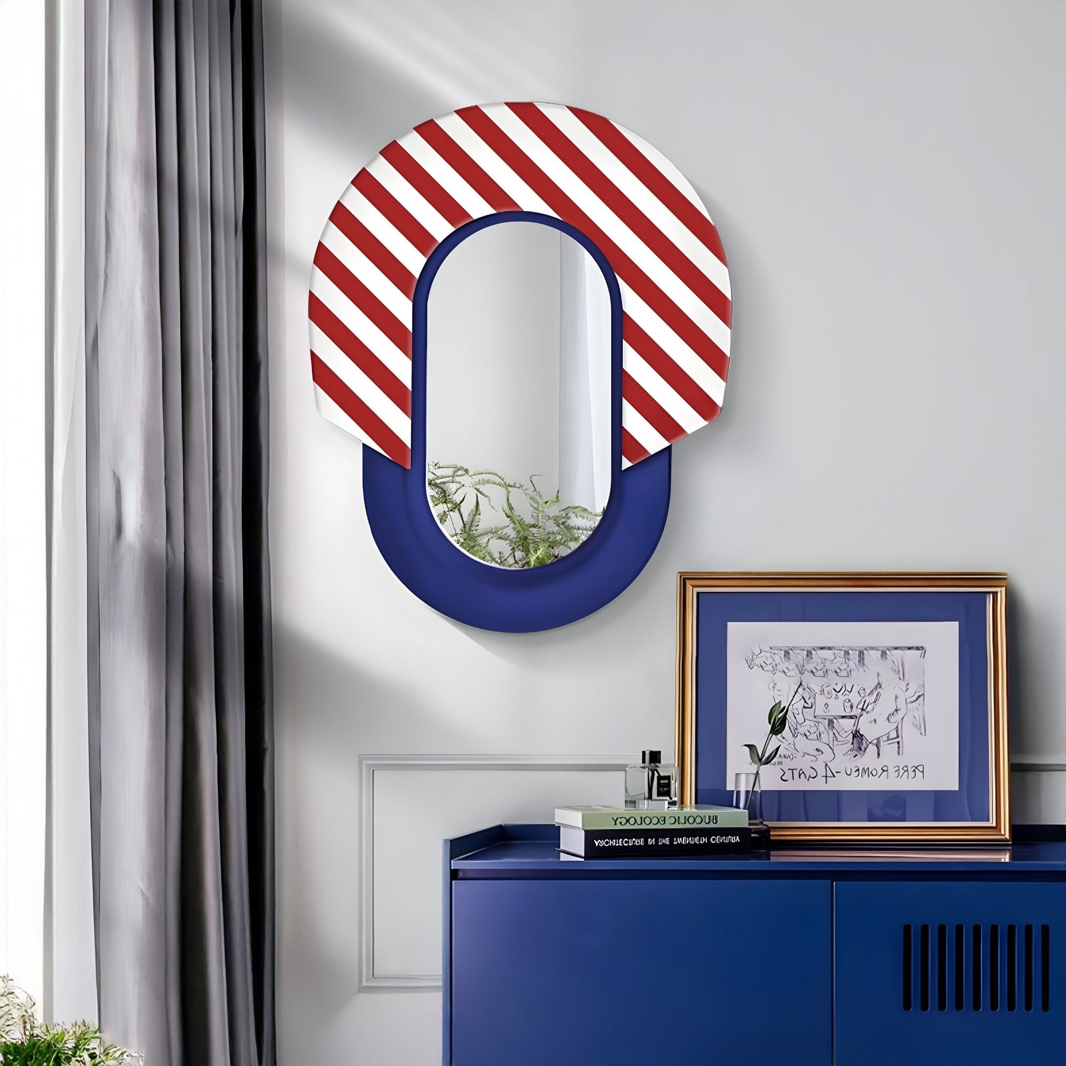 A modern interior features Giant Sculptures Arcus Blue & Red-White Striped Mirror 3D Wooden Wall Art above a blue cabinet. A small plant adds charm, and gray curtains complete the look.