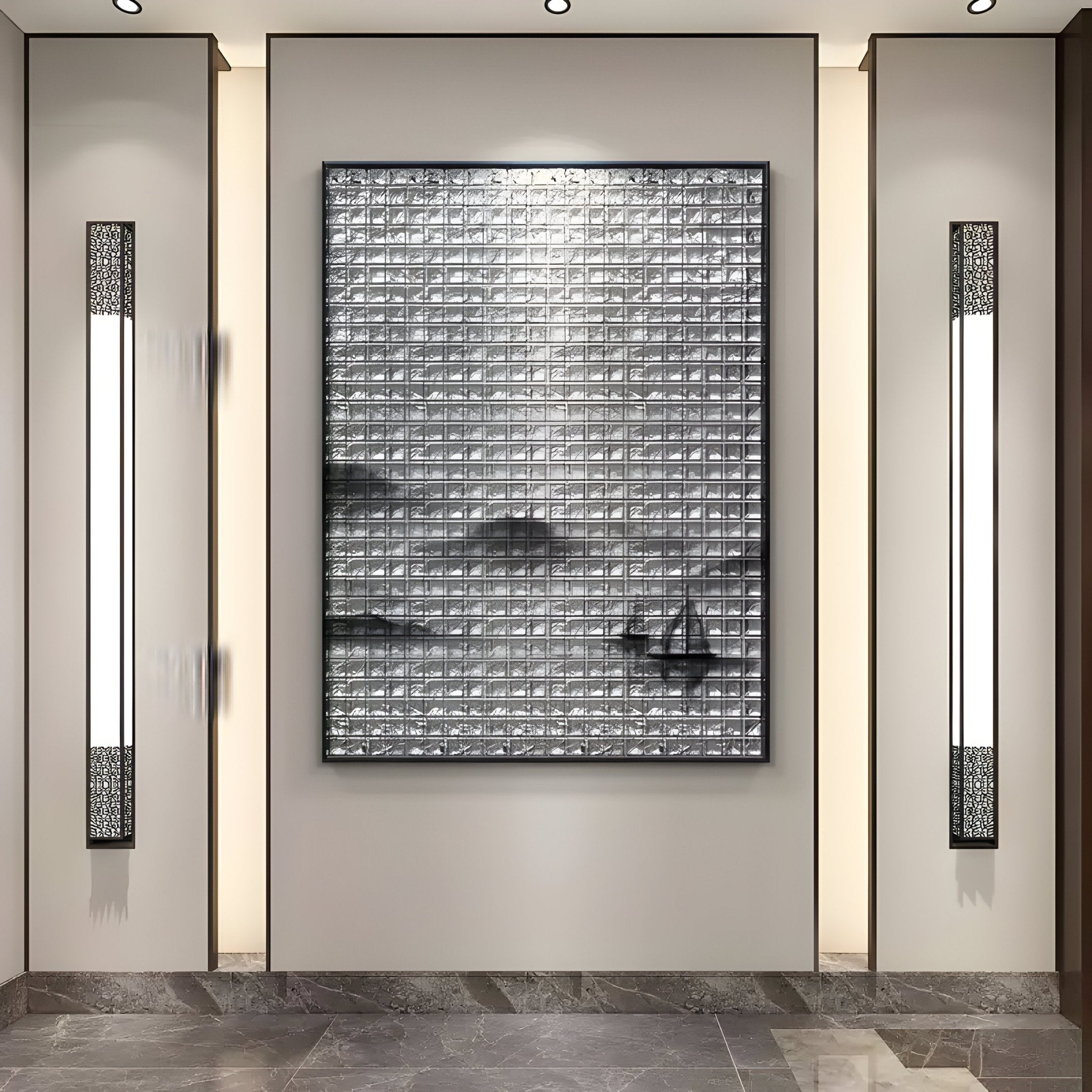 The Synova Silver II Hand-Painted Wood Relief 3D Wall Art by Giant Sculptures, a large textured monochrome piece, hangs on a softly lit neutral wall, flanked by two modern vertical light fixtures above polished gray marble tiles.