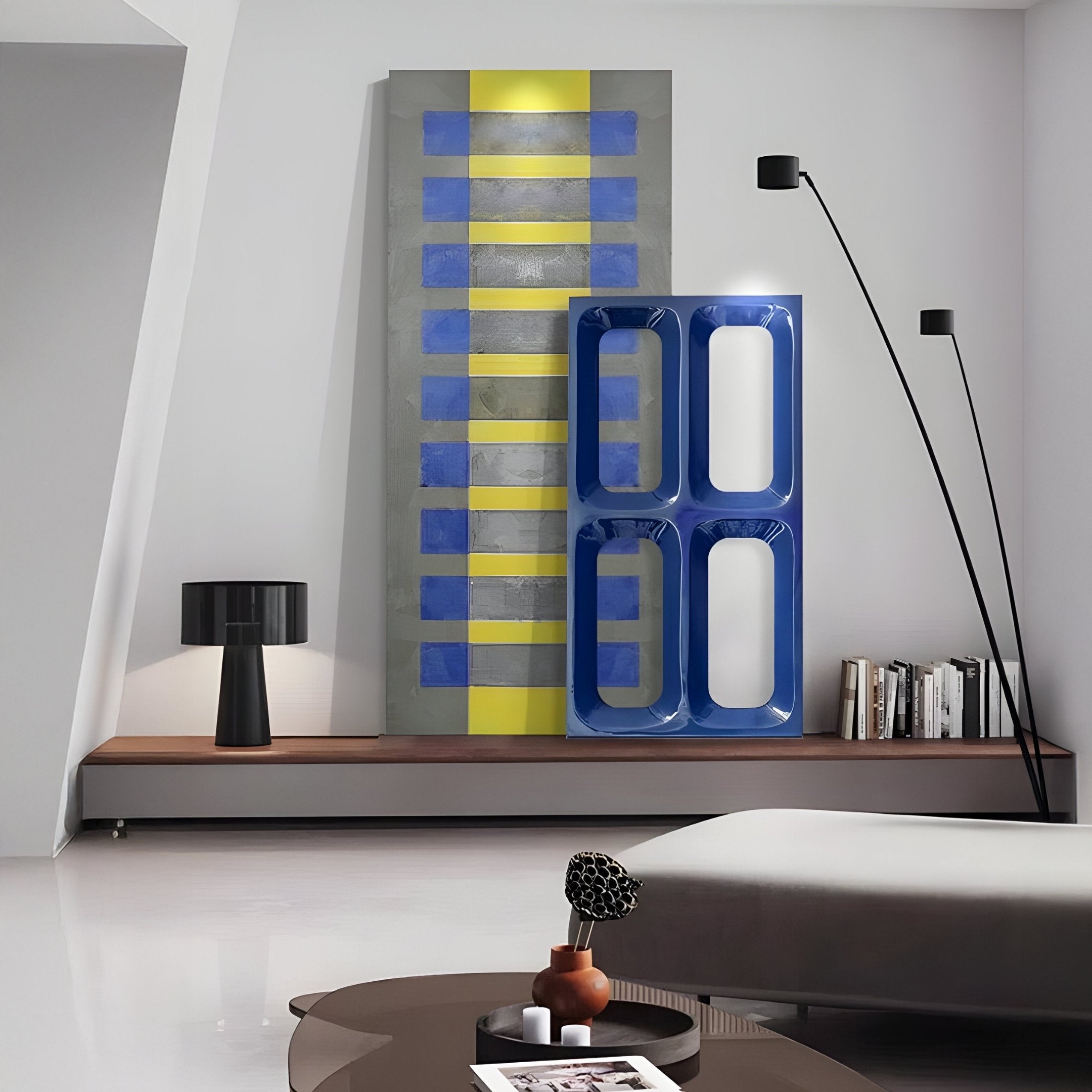 A modern, minimalist room showcases the Lineris Blue Glossy Wood Relief 3D Wall Art by Giant Sculptures featuring abstract blue and yellow vertical shapes. A sculptural decor sits on a low platform with a sleek black lamp, while a curved floor lamp elegantly arches over the serene space.