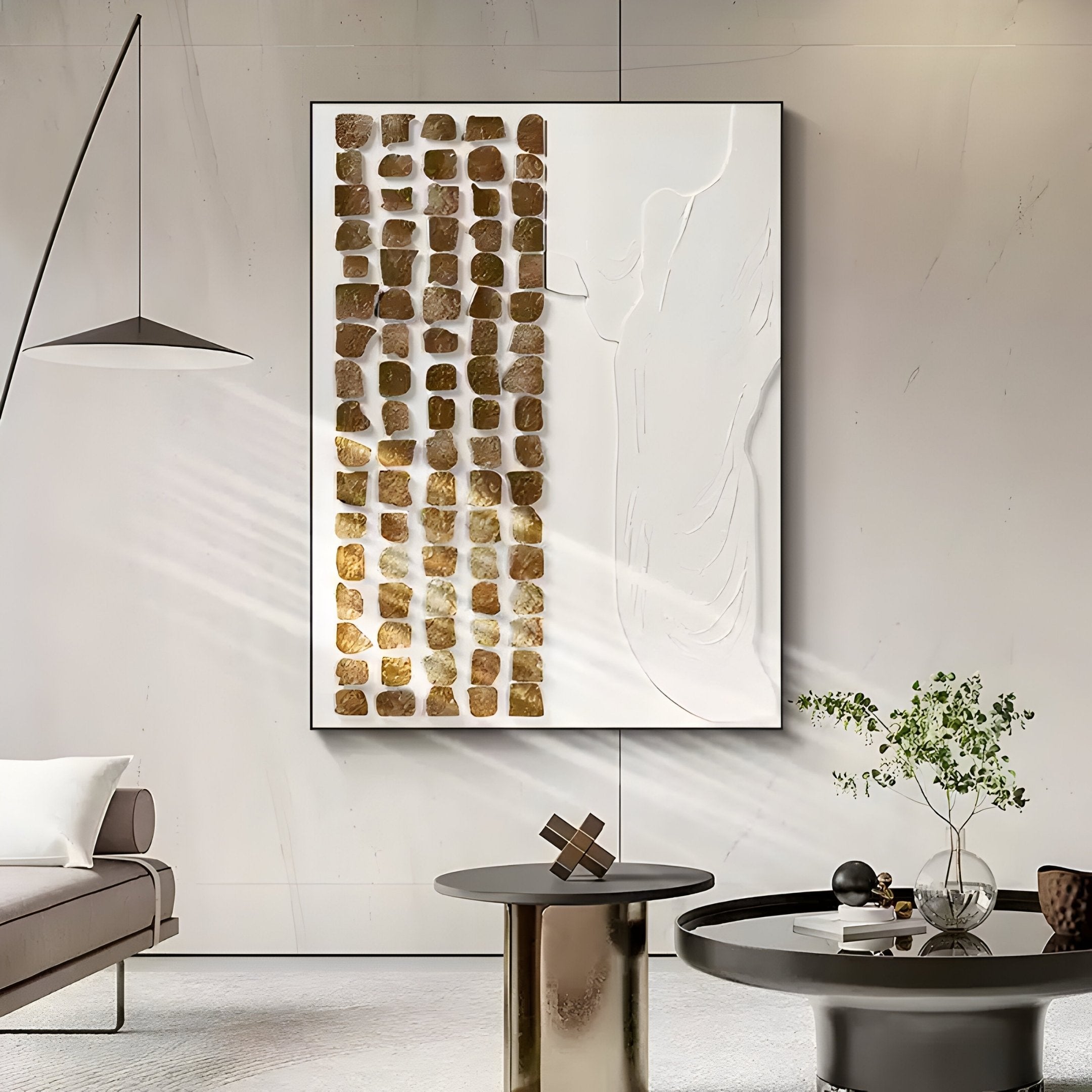 A modern living room features the Aestilis Olive & White Mosaic Wood Carving 3D Wall Art by Giant Sculptures, combining textured gold squares with abstract shapes. It also includes a sleek gray sofa, a round black coffee table with decor, and a small potted plant in Wabi-Sabi style.