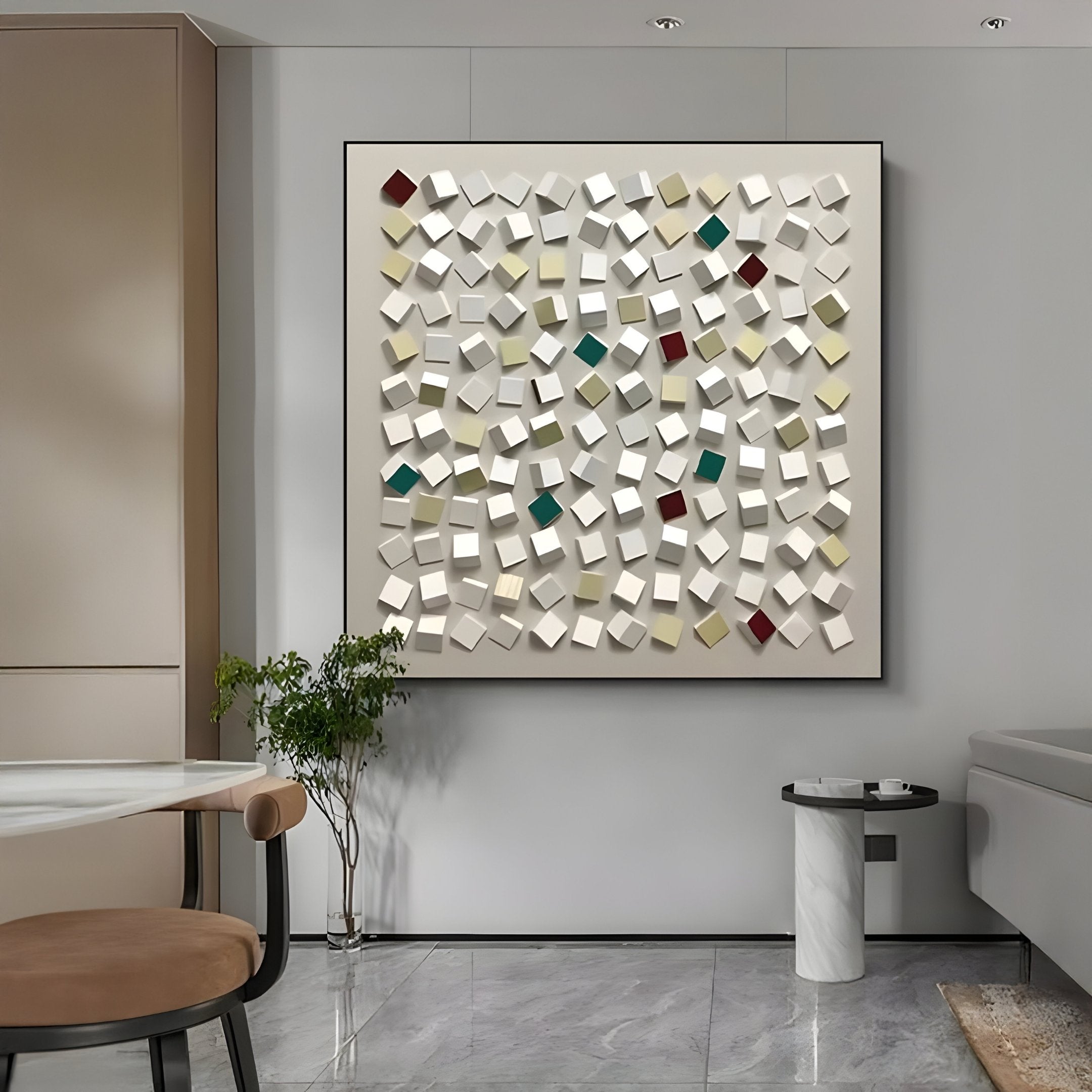 A modern living space features Giant Sculptures Formexa Cube Geometric Wood Relief 3D Wall Art with an abstract arrangement of many small white cubes, plus red, green, and yellow ones on a gray wall. Complementing this is a marble floor, round table with a brown chair, and a small plant.