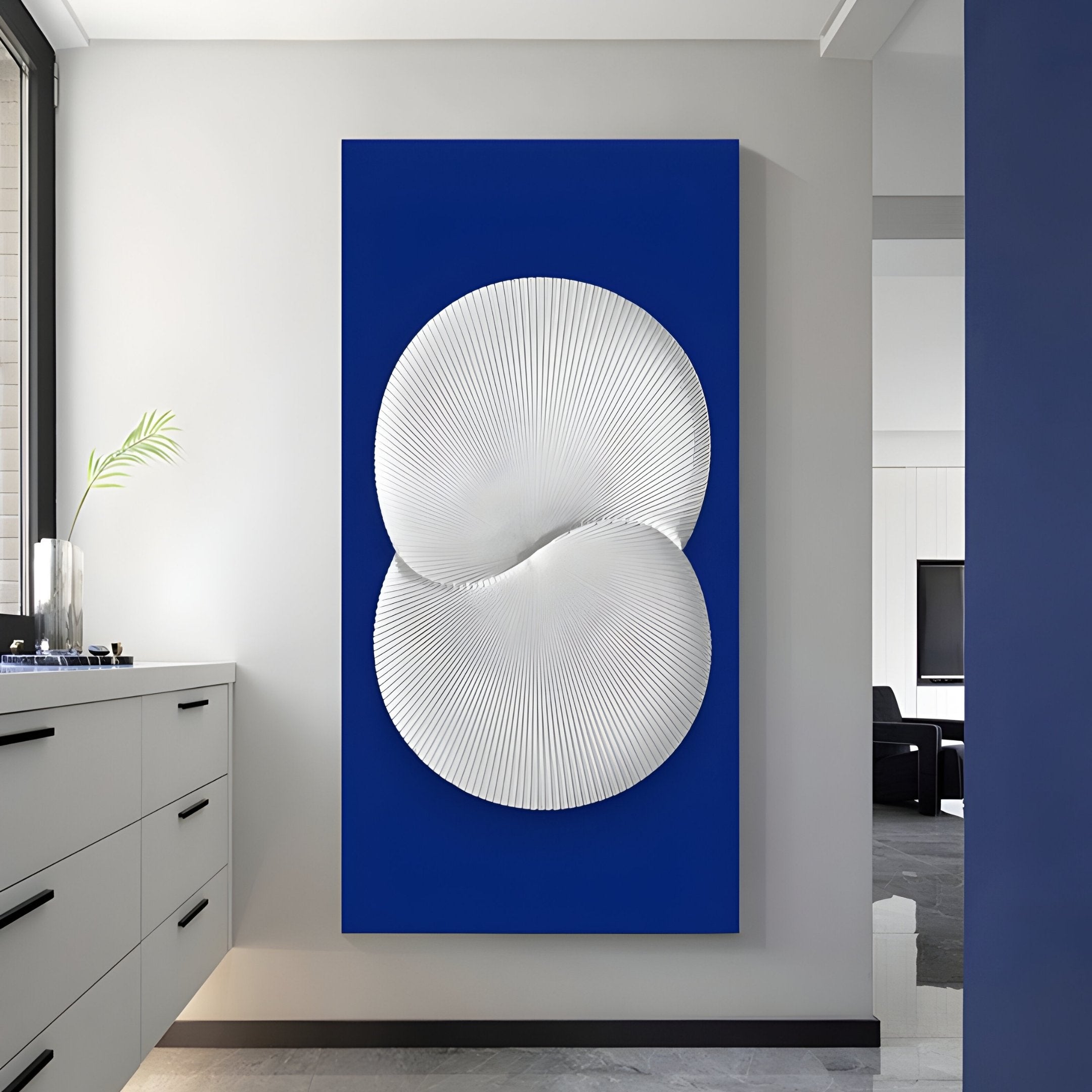 The Artivio Blue & White Wood Relief 3D Wall Art by Giant Sculptures showcases an abstract white circular design with textured patterns on a vibrant blue rectangular canvas, seamlessly fitting into contemporary spaces with minimalist elegance through its clean lines and simplicity.