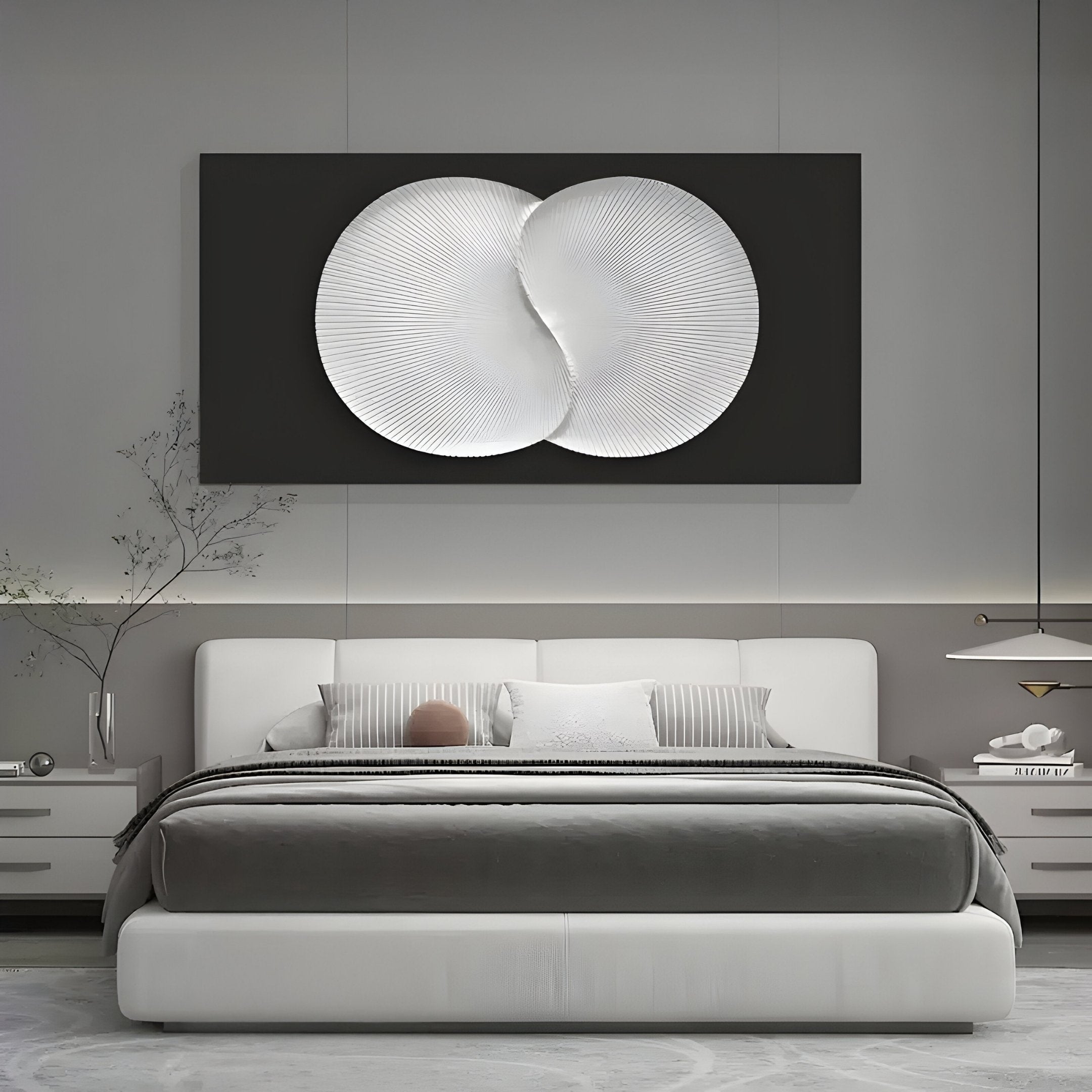 A modern bedroom features a large white bed with striped pillows and a gray blanket, adorned by the Artivio Black & White Wood Relief 3D Wall Art from Giant Sculptures above it. Minimalist decor includes small plants on the nightstands and a sleek pendant light.