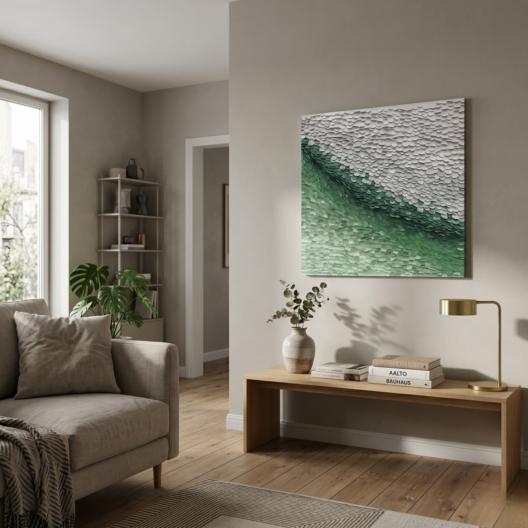 A bright, modern living room with beige walls, a gray sofa, a wooden bench with books and a vase, a gold lamp, Seravelle Green Gradient Layered 3D Paper Wall Art by Giant Sculptures above the sofa, and a window letting in natural light.