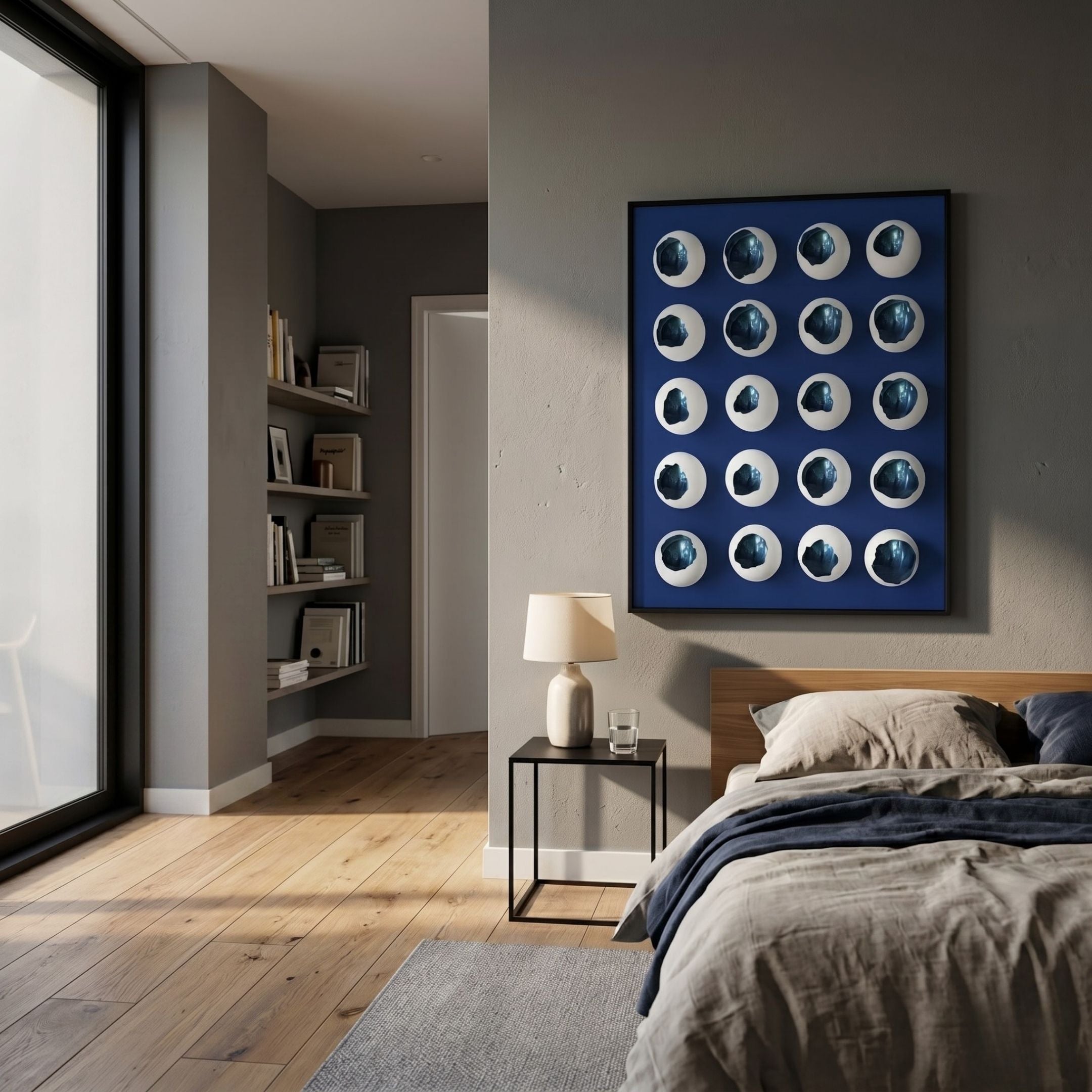 Orbivelle White & Cobalt Patch Sphere Panel 3D Wall Art by Giant Sculptures, displayed above a nightstand and bed in a modern grey bedroom.