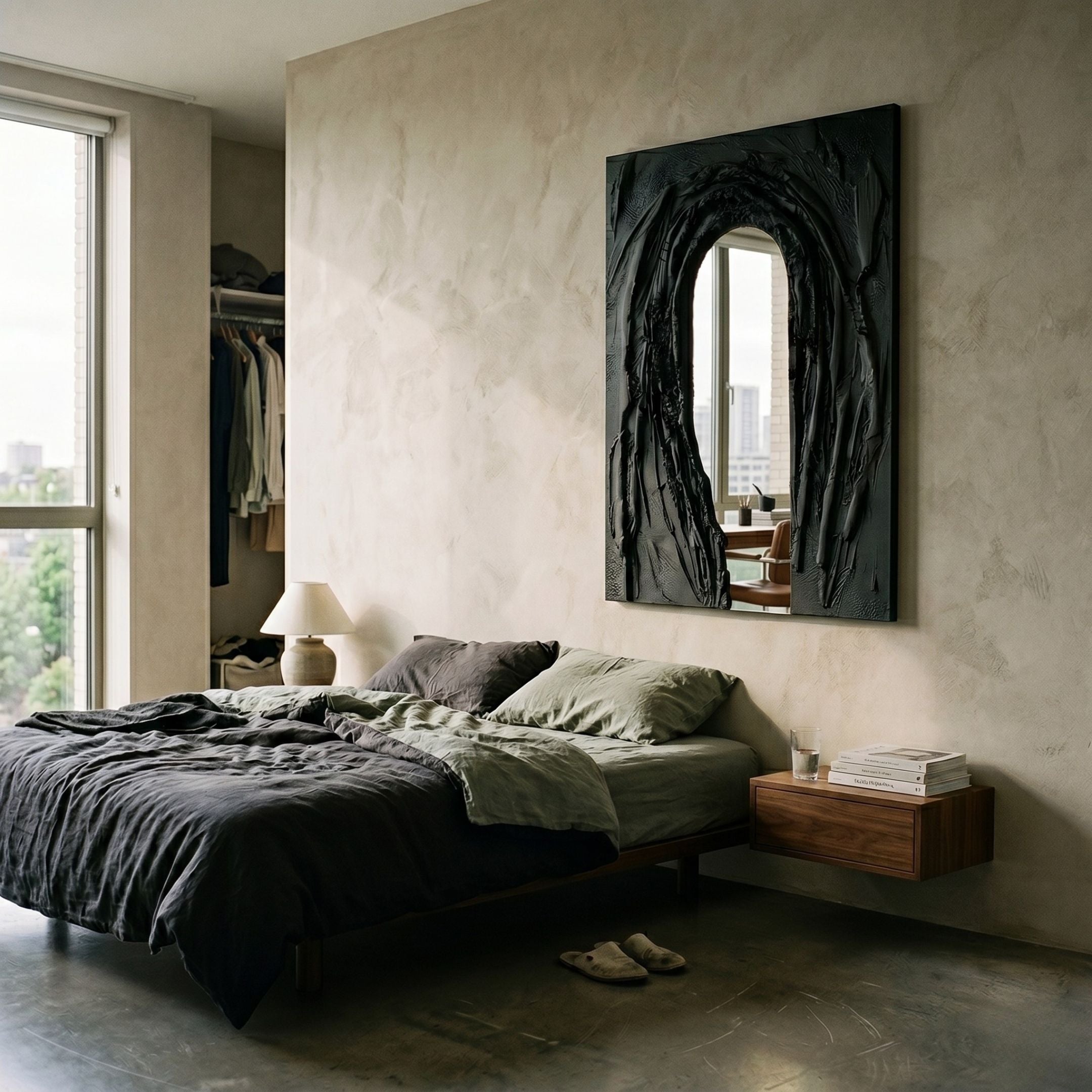 Arclunor Black Arch Relief Mirror 3D Wall Art by Giant Sculptures mounted above a low bed with green and charcoal linens in a textured plaster bedroom.