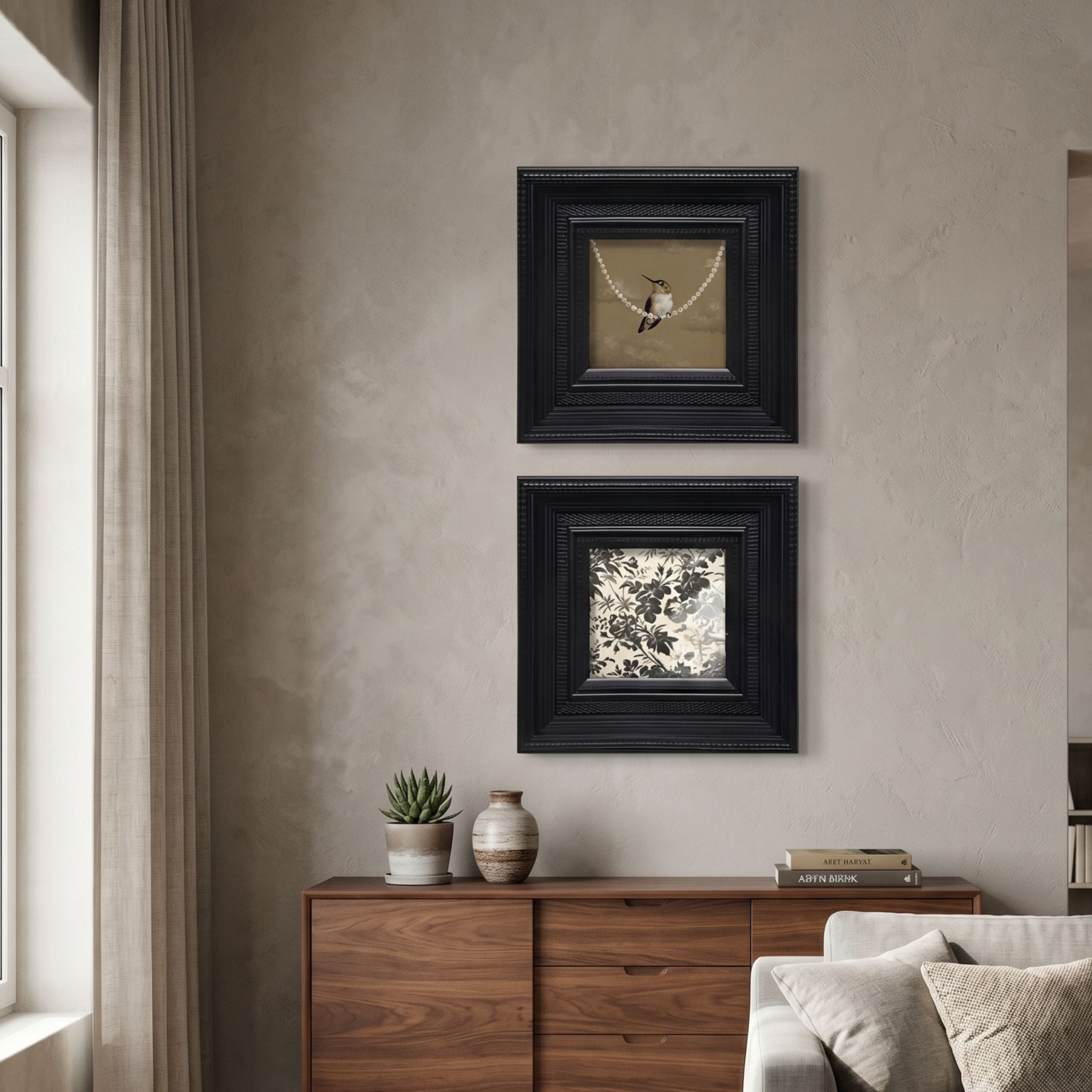 Artelis 2-Set Bird & Floral Pattern Framed Wall Art in black wood frames, hung vertically above a walnut sideboard with potted succulent and vase.