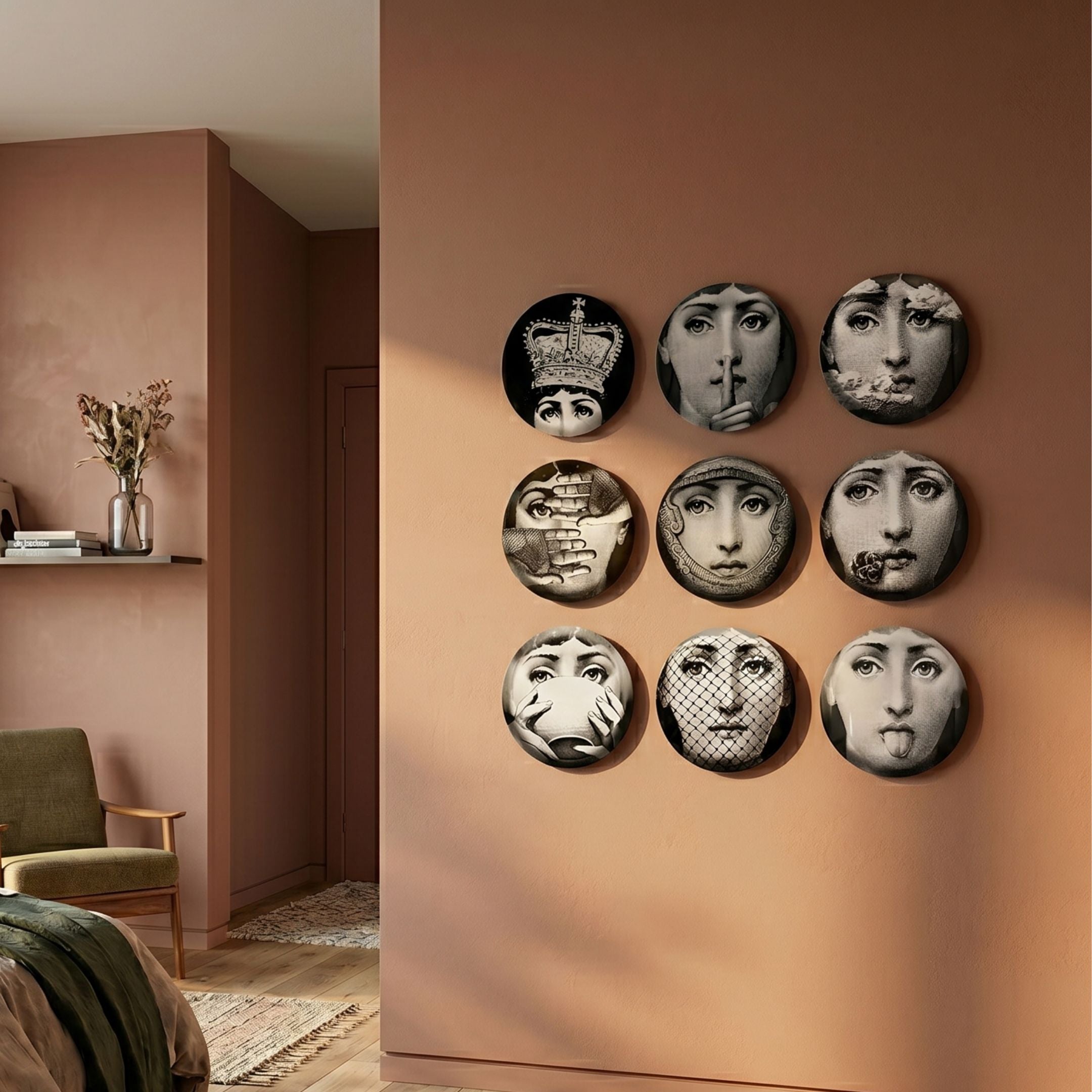 Lunoria Surreal Face 9-Set Round Wood Embossed Wall Art by Giant Sculptures arranged in a 3×3 grid on a terracotta bedroom wall beside a green armchair.