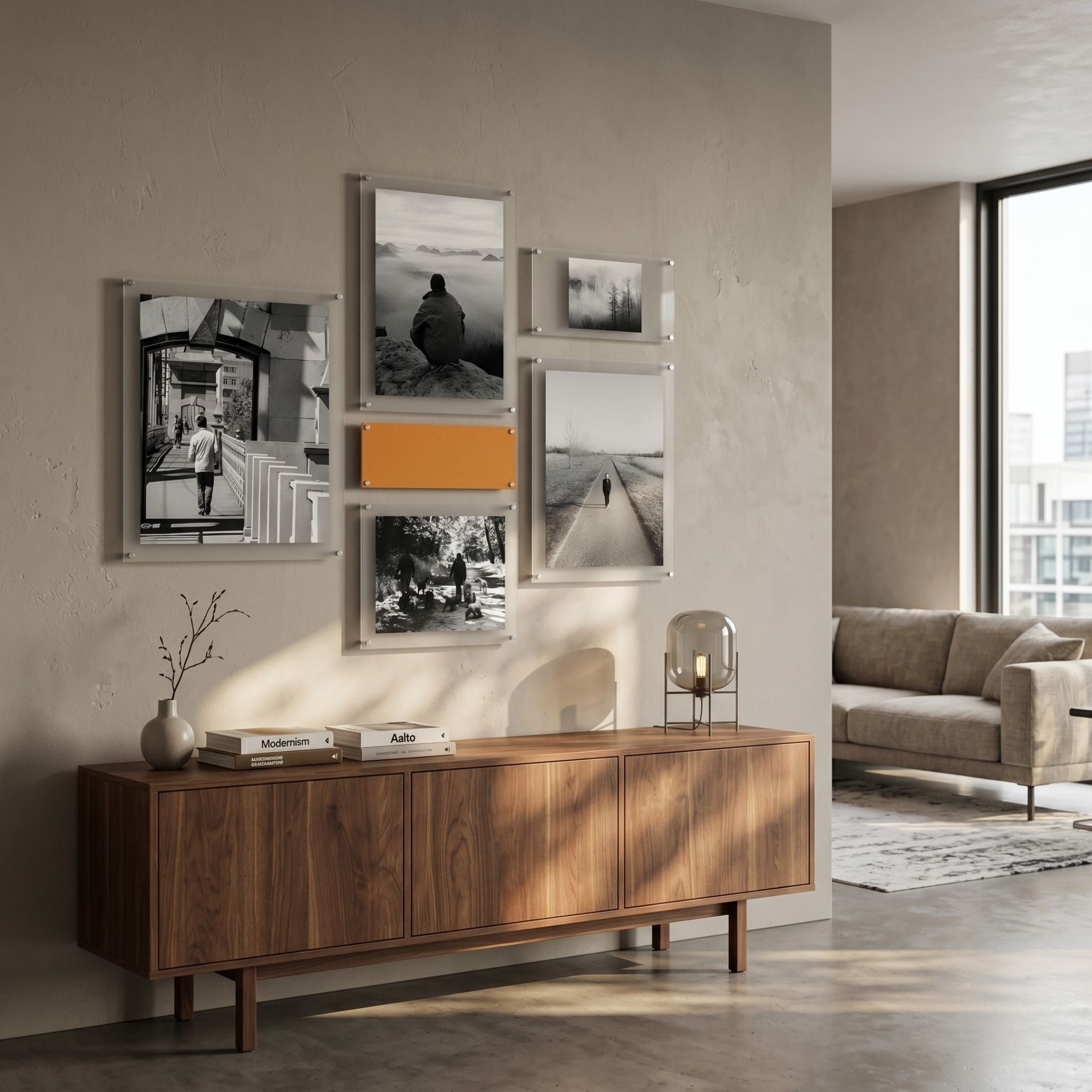 Framegrid Orange Mixed-Size Gallery 6-Set Acrylic Wall Art by Giant Sculptures, five black-and-white prints with one orange panel, above a walnut sideboard.