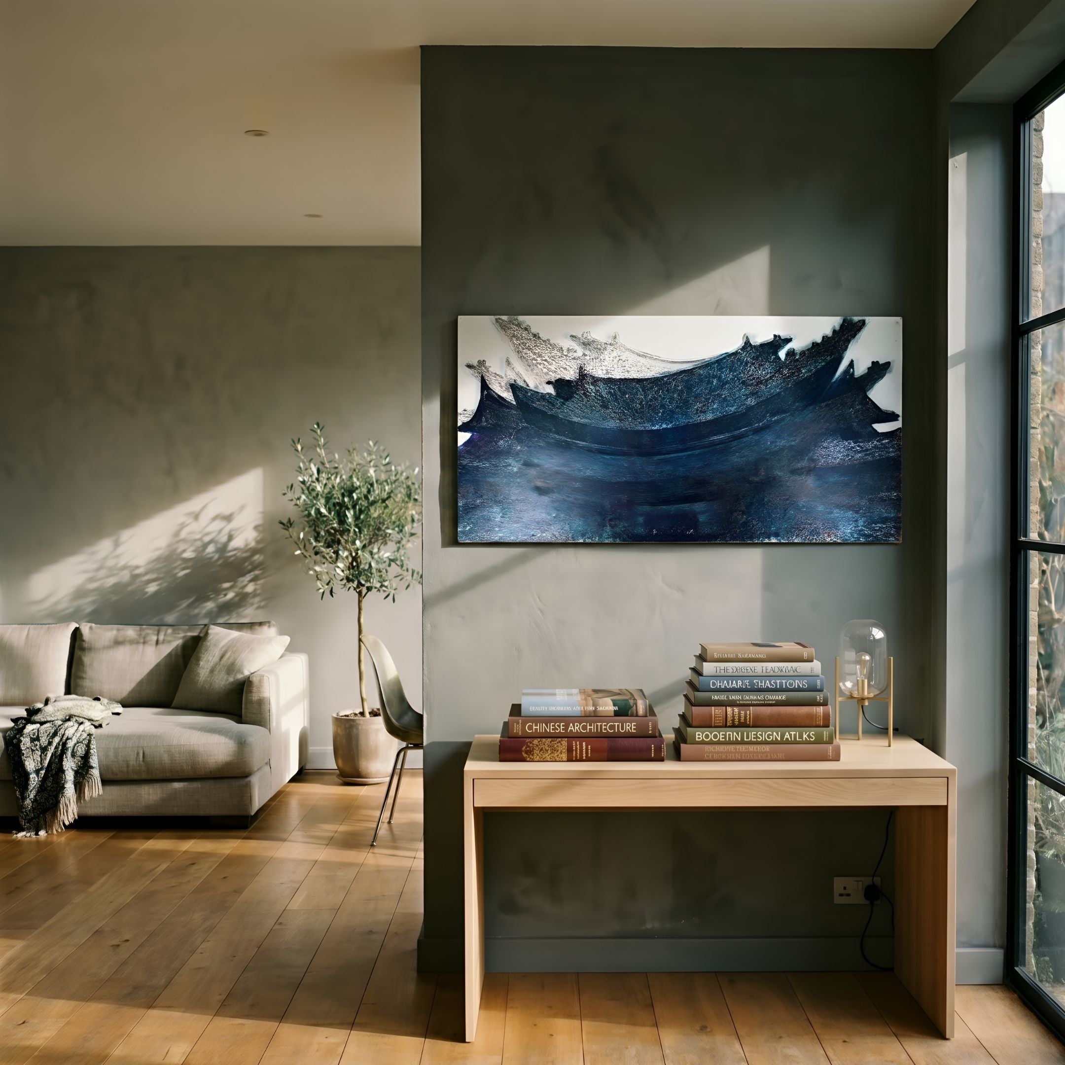 Minara Indigo Twilight Pagoda 3D Button Wall Art by Giant Sculptures displayed above a wooden console table in a sunlit living room with sofa and olive tree.