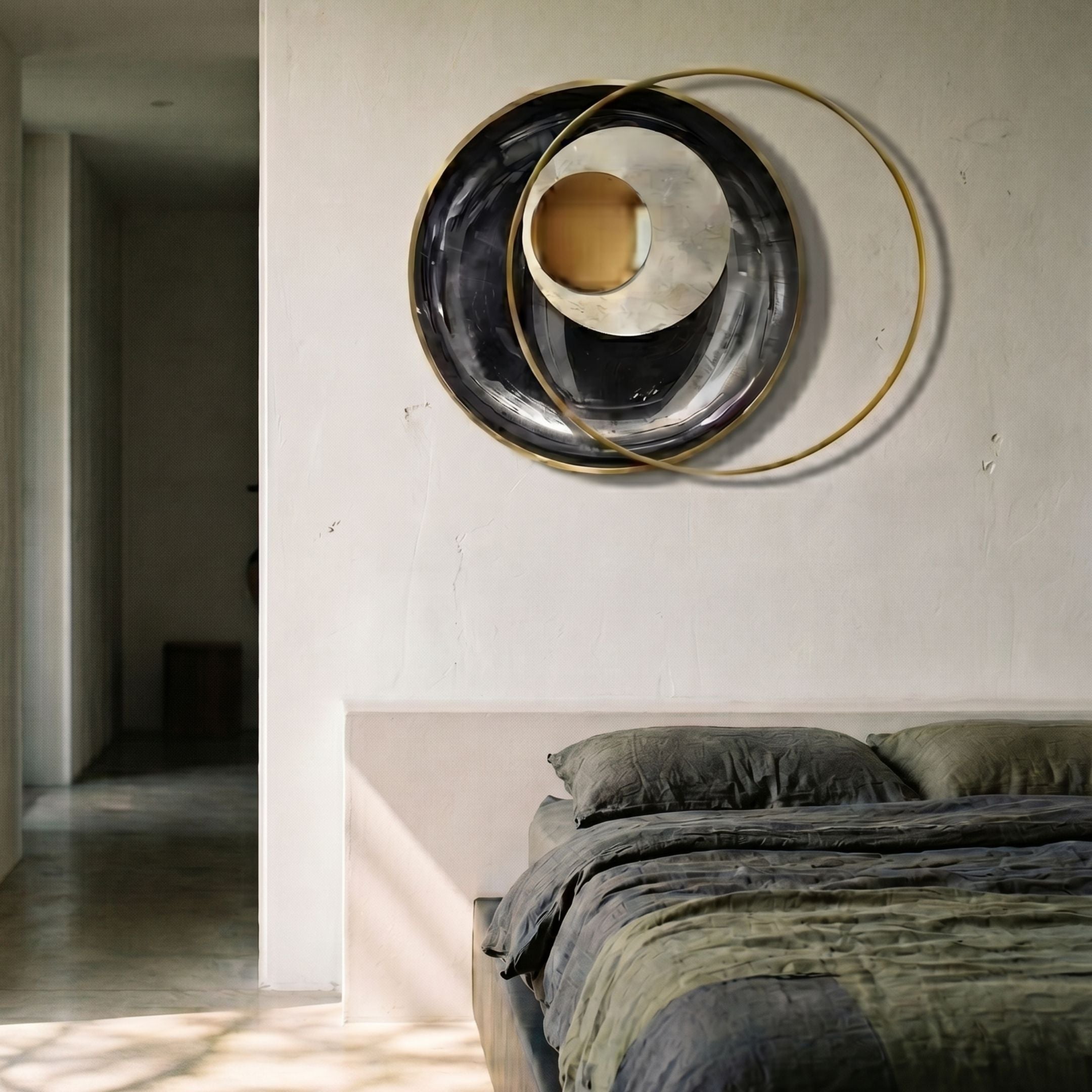 Solvata Charcoal Orbit & Metal Ring 3D Wall Art by Giant Sculptures, glossy black plate with gold disk and slim rings, mounted above a bed in a sunlit bedroom.