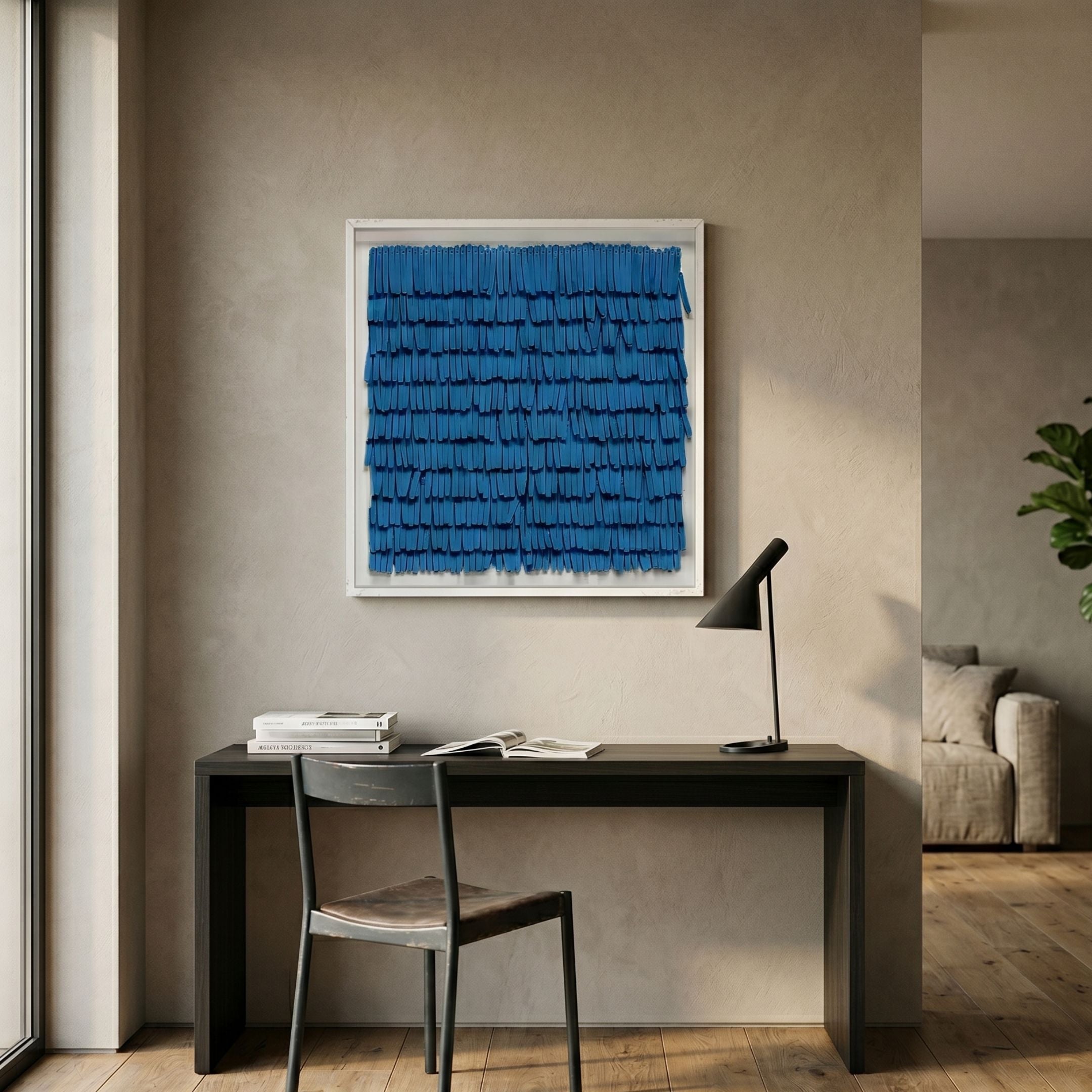 Frondra Blue Layered Leather 3D Wall Art by Giant Sculptures displayed in a modern home office above a dark desk with a black task lamp and chair.