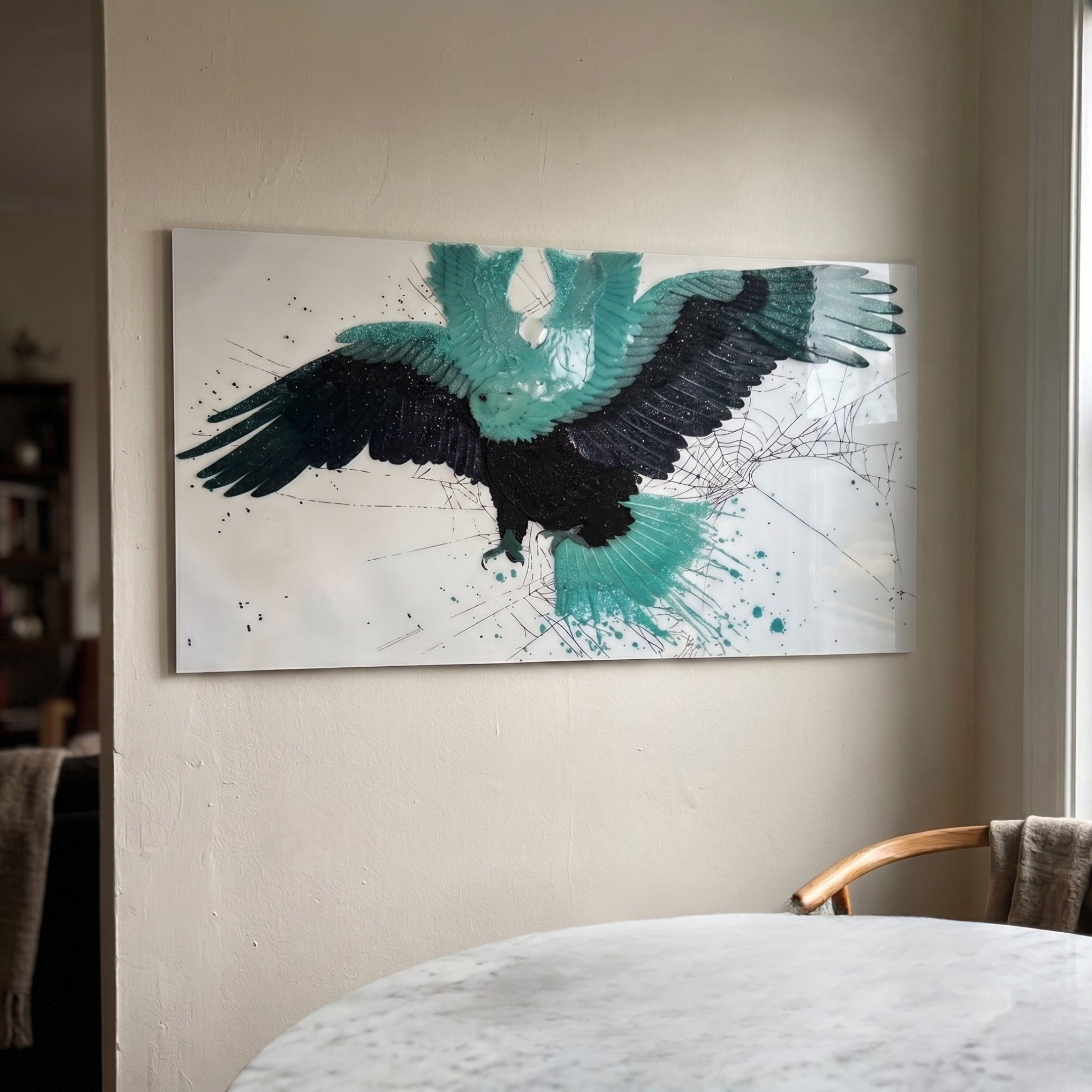 Aurellion Teal Eagle Flight & White Panel 3D Button Wall Art by Giant Sculptures mounted on a beige wall above a marble dining table, showing a spread-winged eagle in teal and black with splatter details on a white panel.