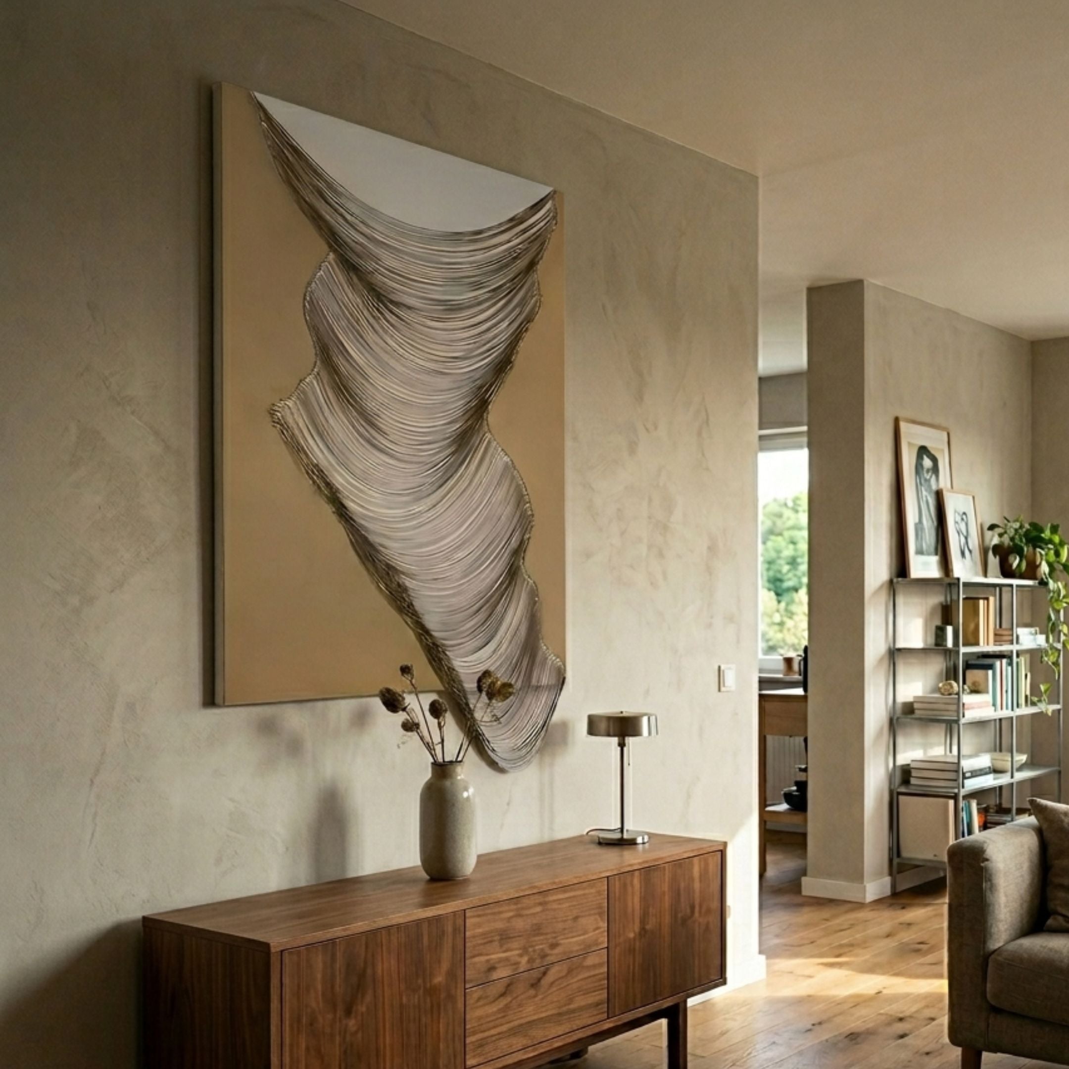 Arvinea Soft Gold Flow Sculptural Leather 3D Wall Art with flowing white leather waves on a beige-gold panel, mounted above a walnut sideboard in a living room.