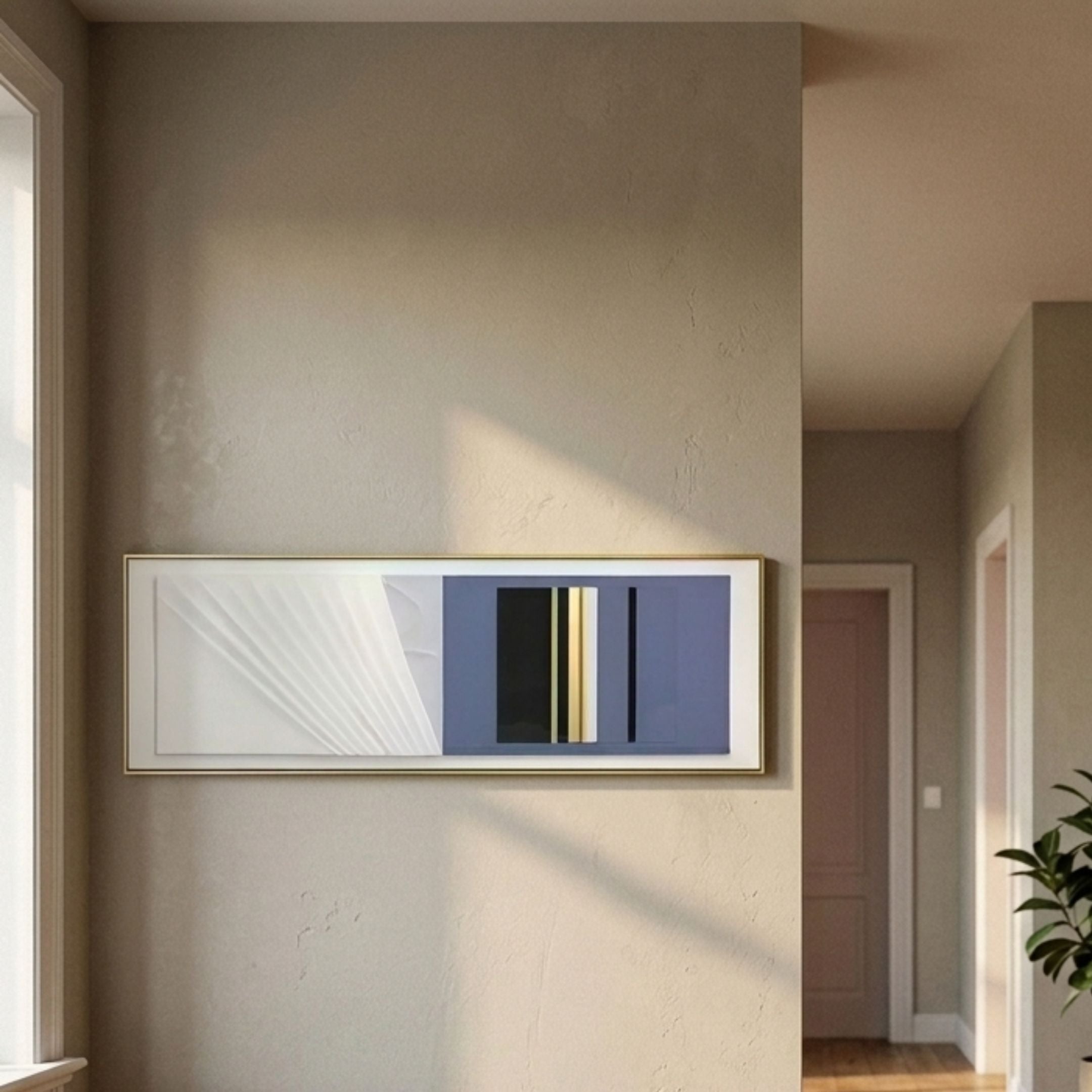 Velvaris Blue & White Panelled Leather 3D Wall Art by Giant Sculptures displayed in a sunlit hallway with cream walls, showing rippled white leather beside slate blue, black, and gold vertical bands in a gold frame.